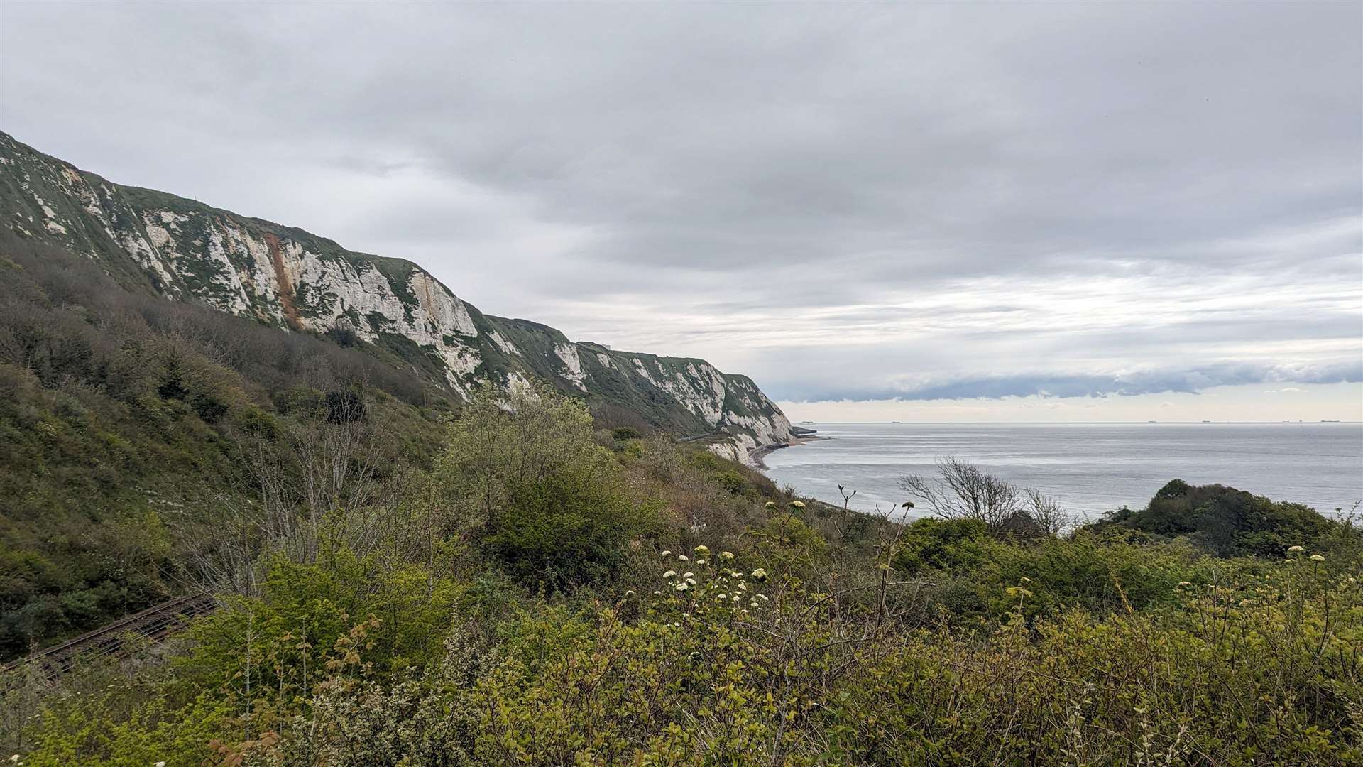 The railway line at the Warren runs between the sea and the cliffs