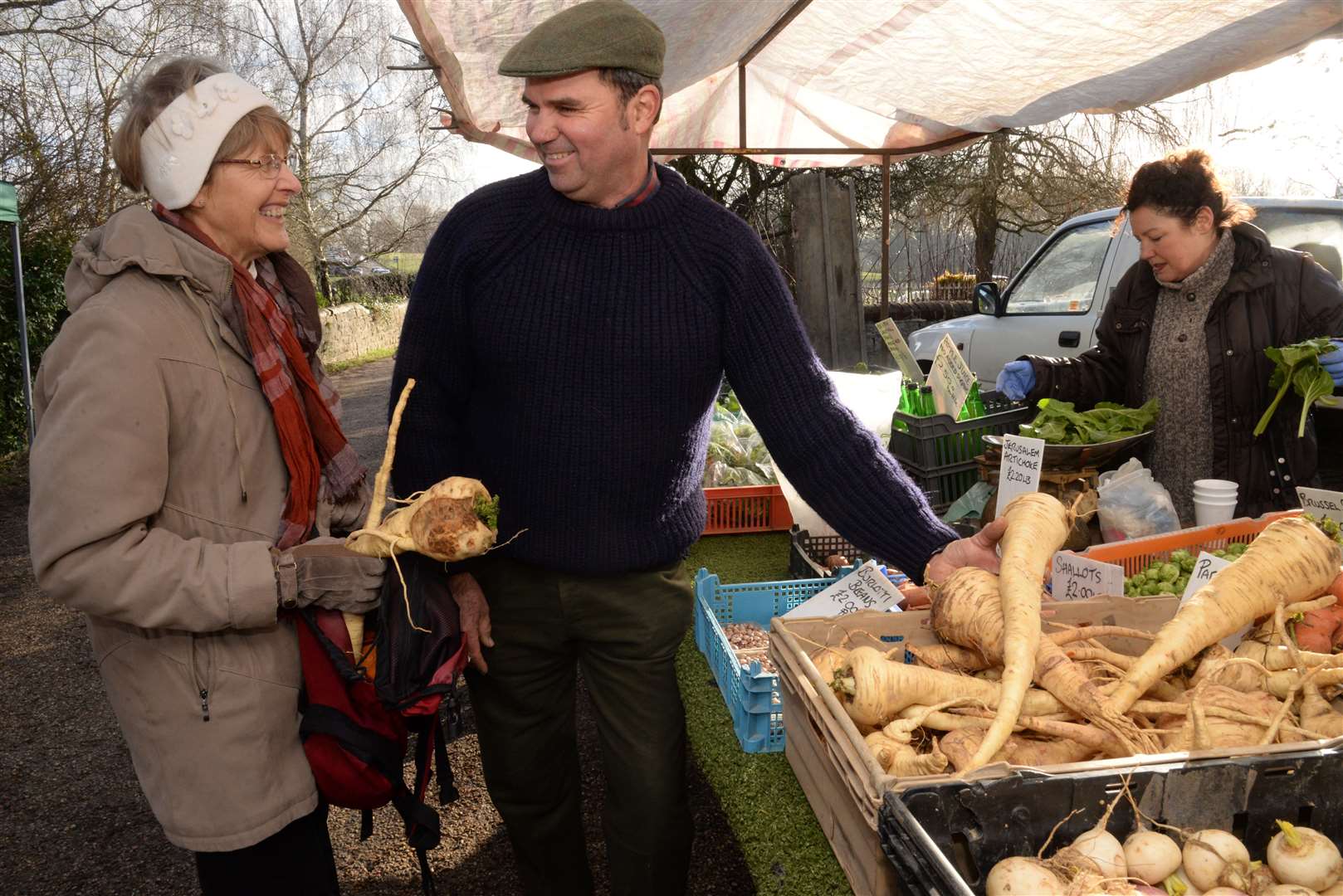 Gary Curd of Oakapple Farm, Yalding sells Brenda Mullinger some of his inpressive parsnips at a previous Shipbourne market Picture: Chris Davey