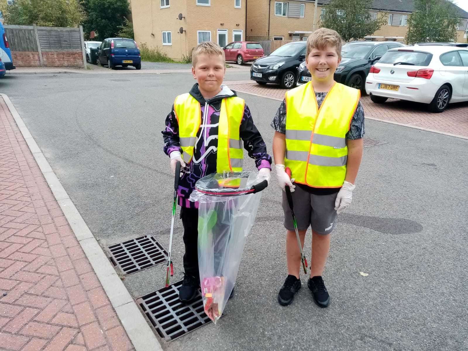 Two boys litter picking as part of the hub's work. Picture: Strengthening Minds