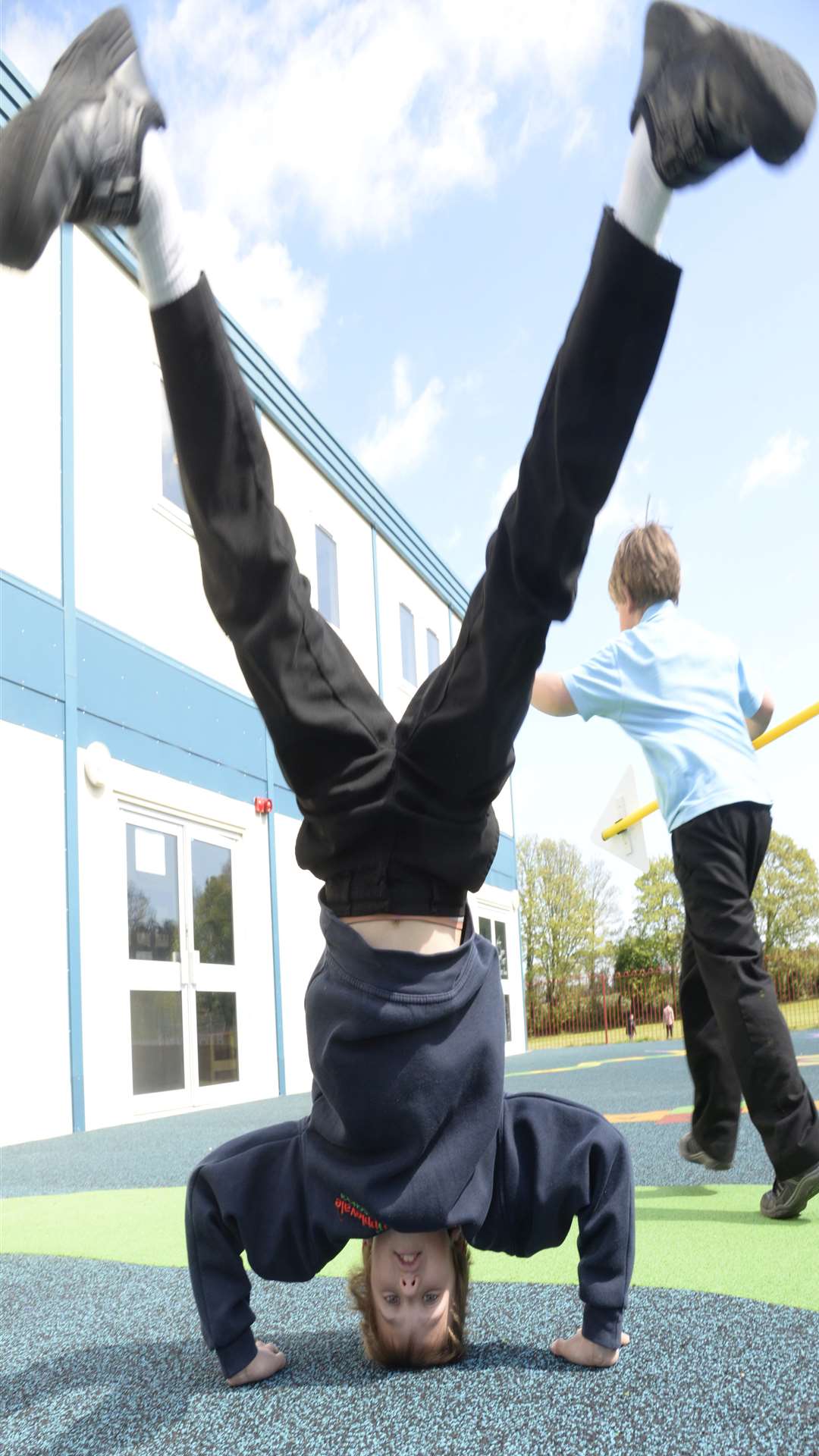 Harry, nine, takes an upside down view of the new playground