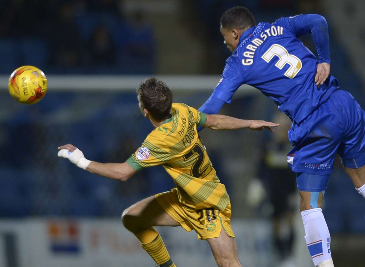 Gillingham's Bradley Garmston gets above Wes Fogden on Tuesday night. Picture: Barry Goodwin