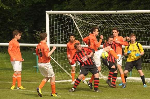Goalmouth action from the under-18 John Leeds Trophy final between Woodcoombe Youth (stripes) and Lordswood Youth Picture: Steve Crispe