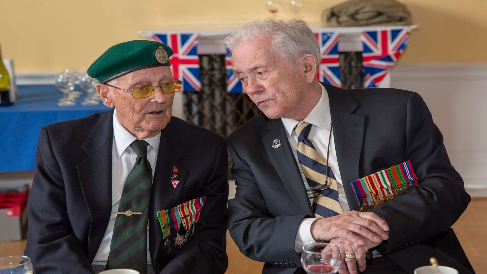 Len Burton, left, and Ronald Hill share memories of VE Day at the 70th anniversary lunch. Picture: Stuart Kirk, Tenterden Photography.