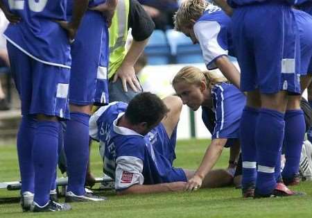 AGONY: Mark Saunders is tended by club doctor Yvette Rean. Picture: BARRY CRAYFORD
