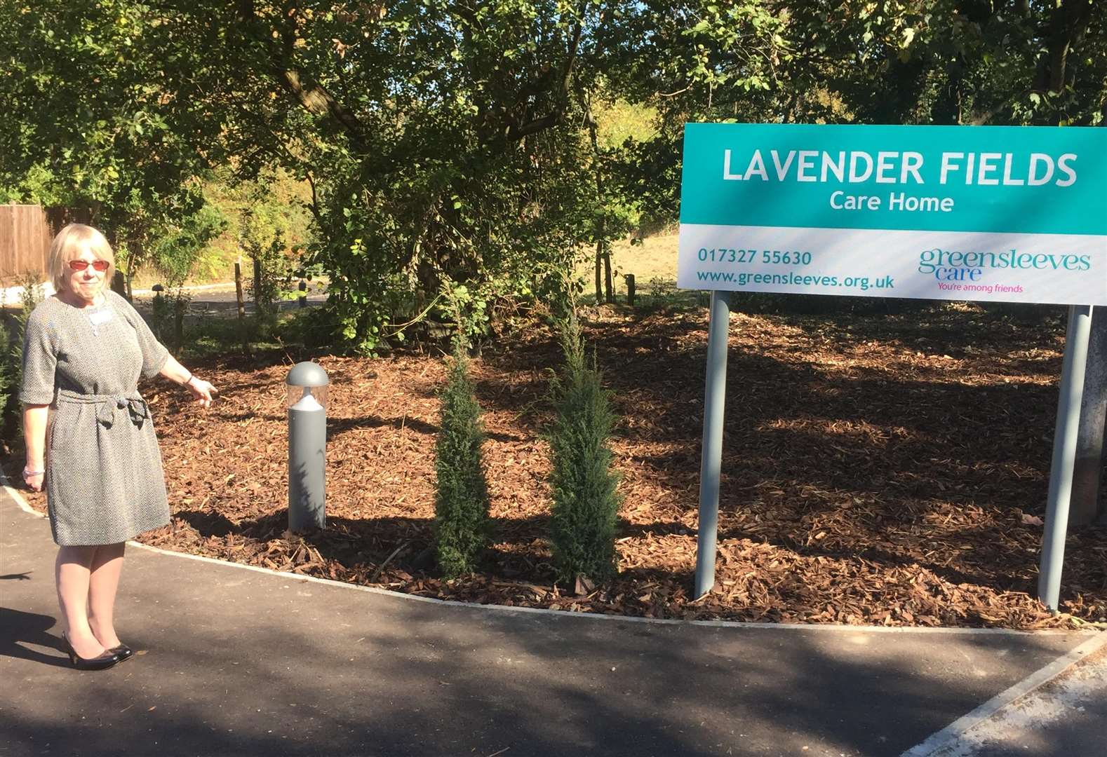 Karen Cooper, Home Manager at Lavender Fields, pointing to the missing conifer trees on the path leading to the care home. (4477538)