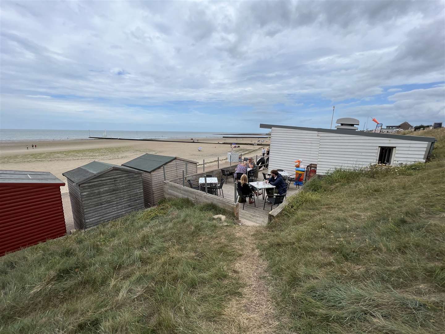 The Windshack in Minnis Bay is nestled behind the huts but with a clear view across the beach