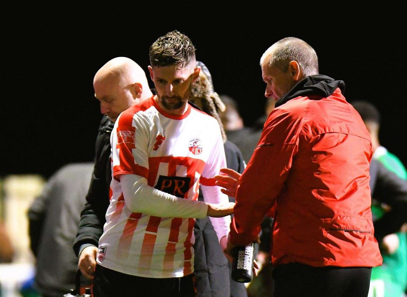 Sheppey striker Dan Bradshaw limps off and shakes the hand of assistant Geoff Record as his night is ended early by injury again. Picture: Marc Richards