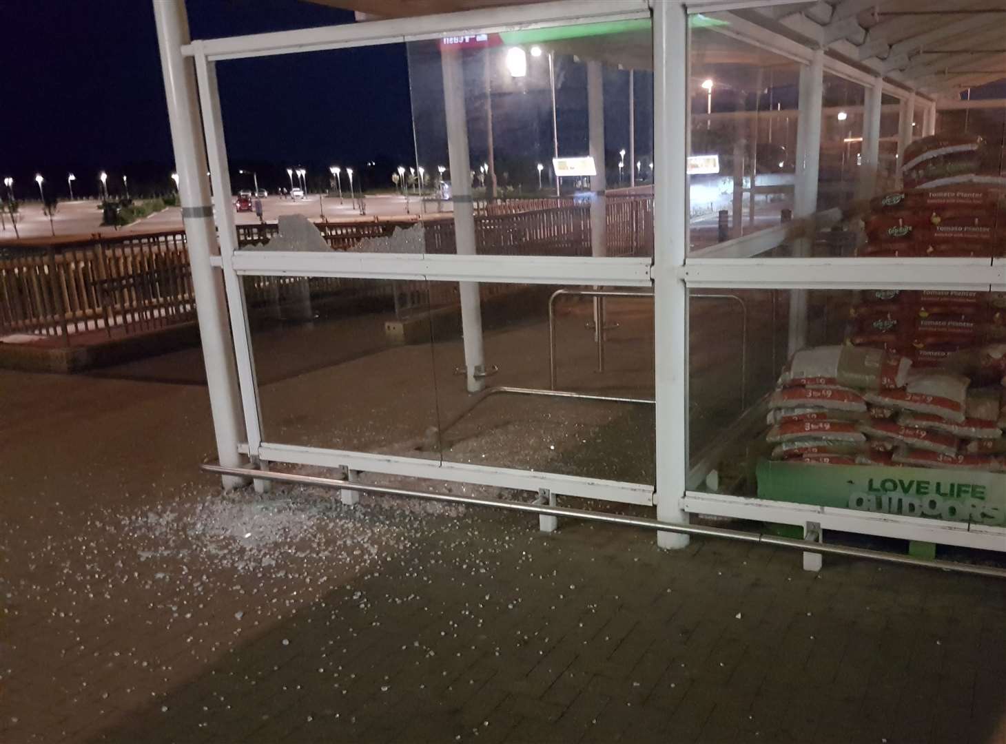 The bike store's window was shattered by a group of teens, and the bike rail behind it uprooted. (14841084)