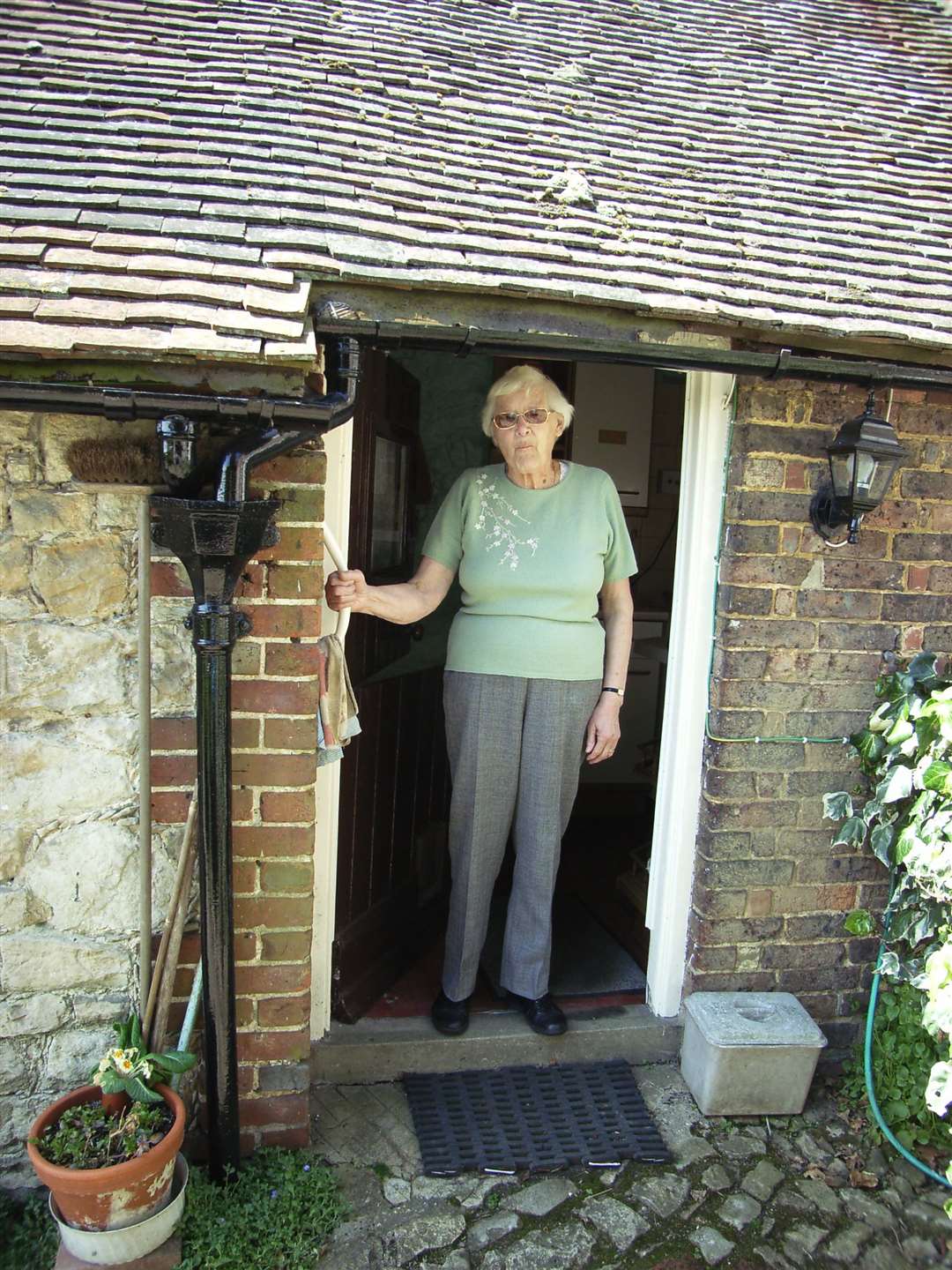 Dorothy Smith at the door too her cottage near Ightham Mote