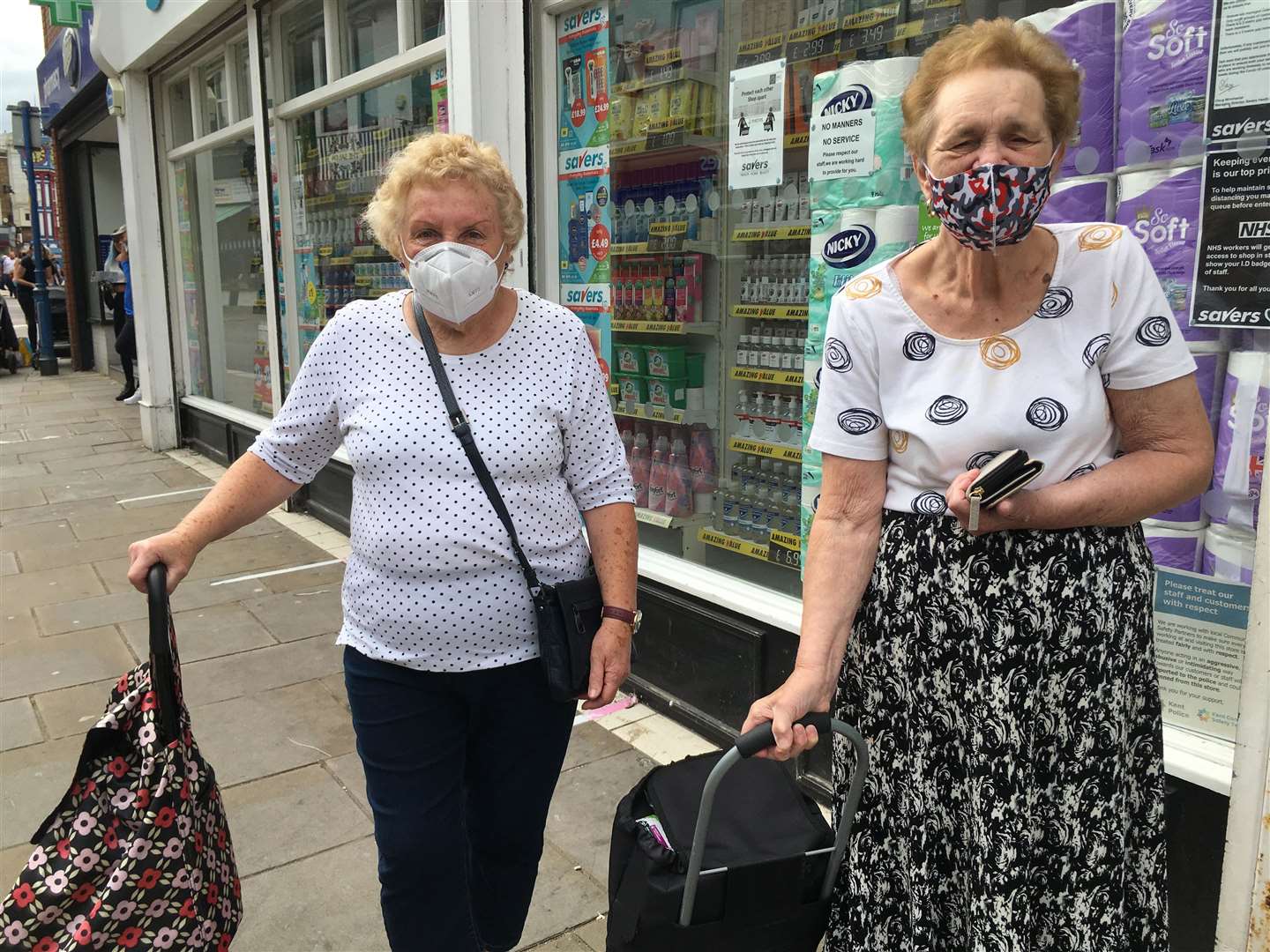 Masked: Sylvia Eldridge, left, and neighbour Patricia Rogers, both 82, in Sheerness during the coronavirus lockdown