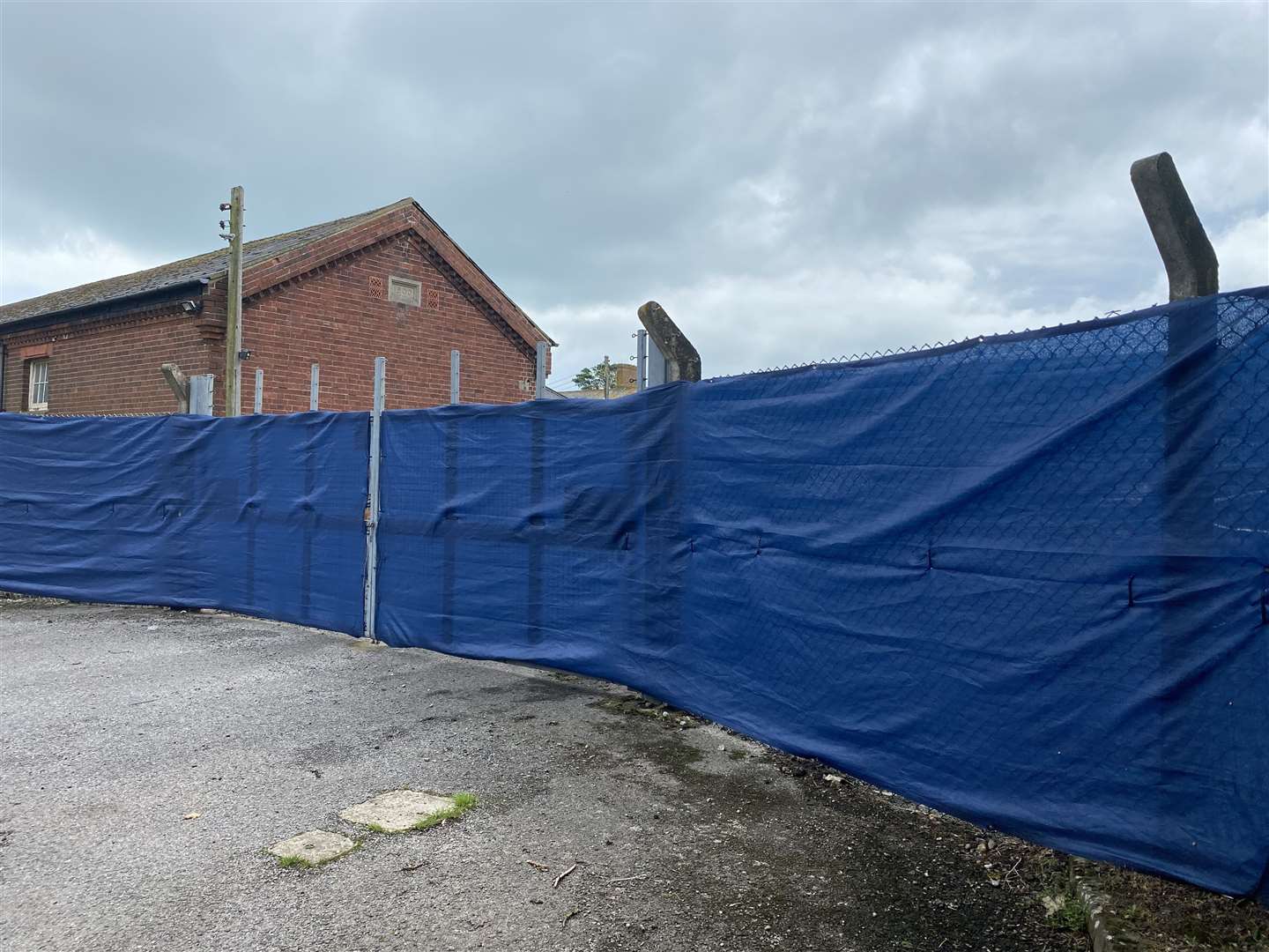 Latest photo from outside Napier Barracks. Blue plastic has been put around the fence