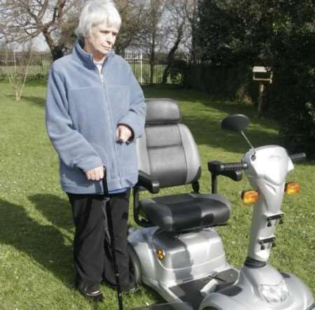 Eileen Marsh with her scooter which is a write-off. Picture: PETER STILL
