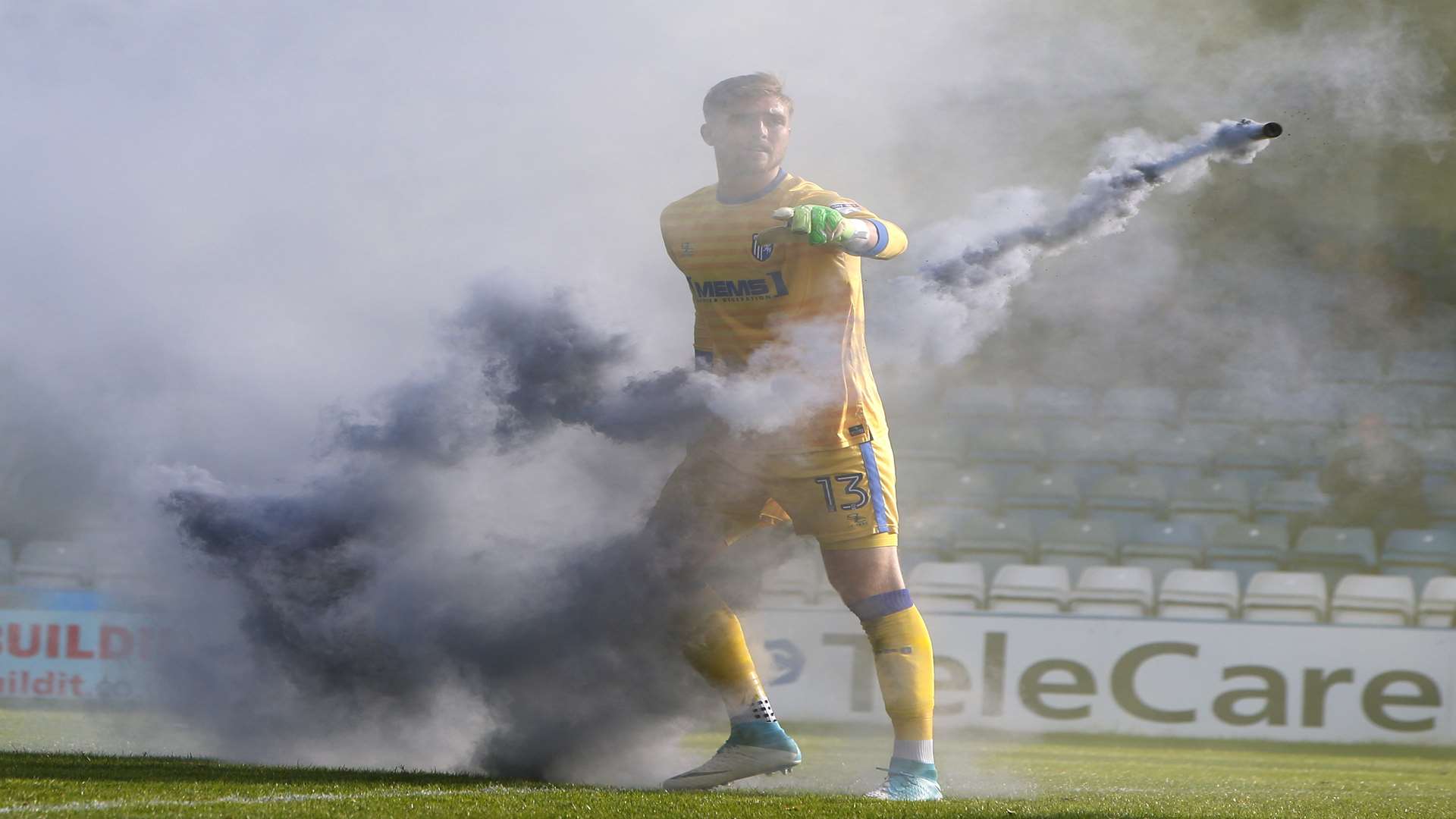 Tomas Holy throws a smoke bomb off the pitch. Picture: Andy Jones