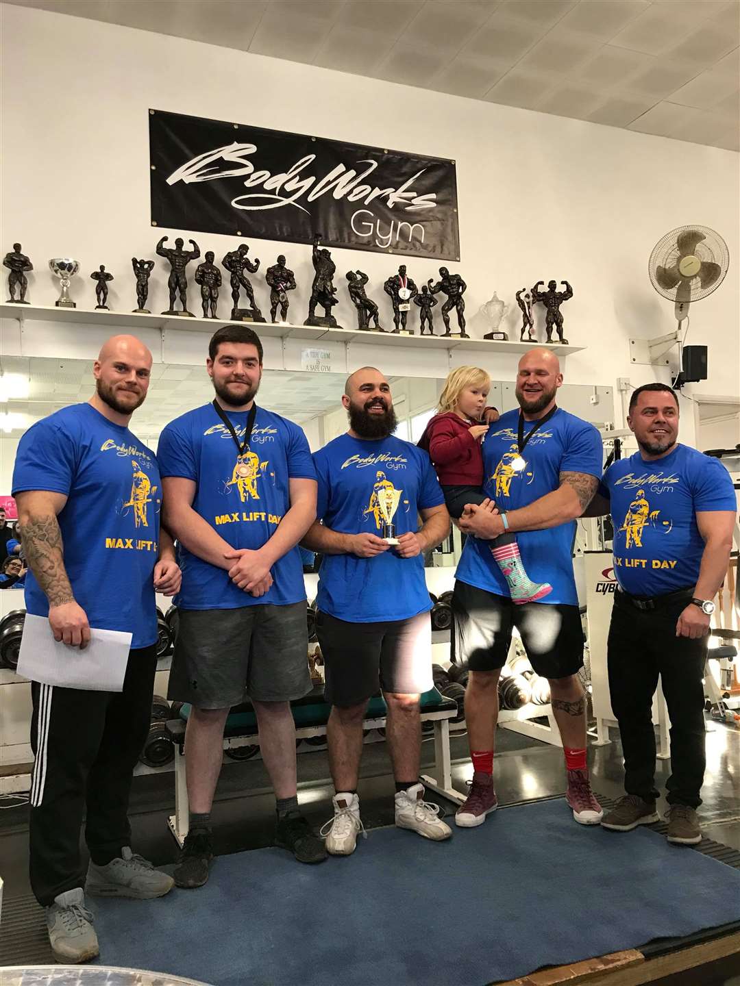 Gym owner Callum Vine congratulates winners of the powerlifting competition (23543759)