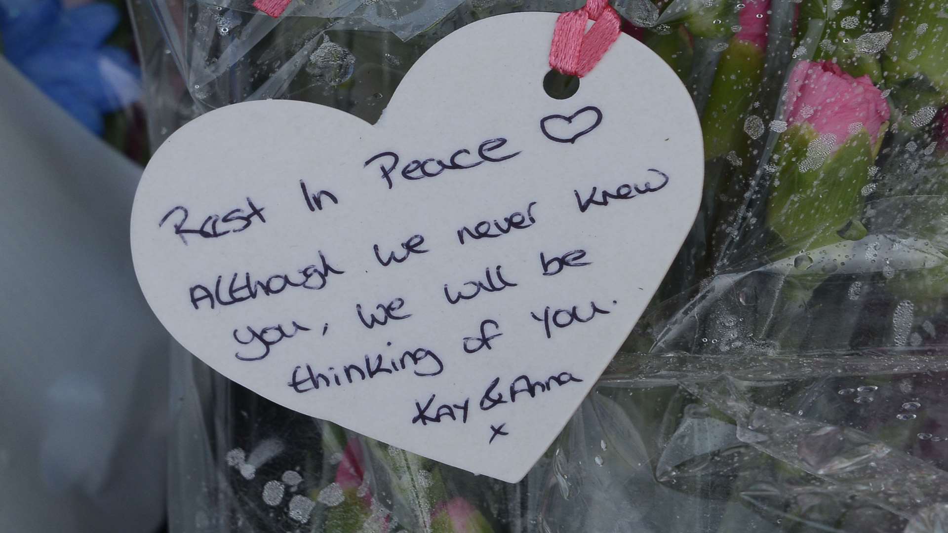 Floral tributes and messages left on the pavement for teenager Luna Barros