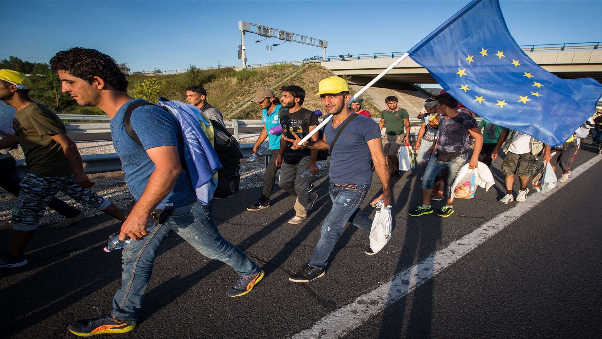 Migrants march long the M1 in Hungary in the direction of Austrian border. Picture: SWNS.COM/Adam Gray