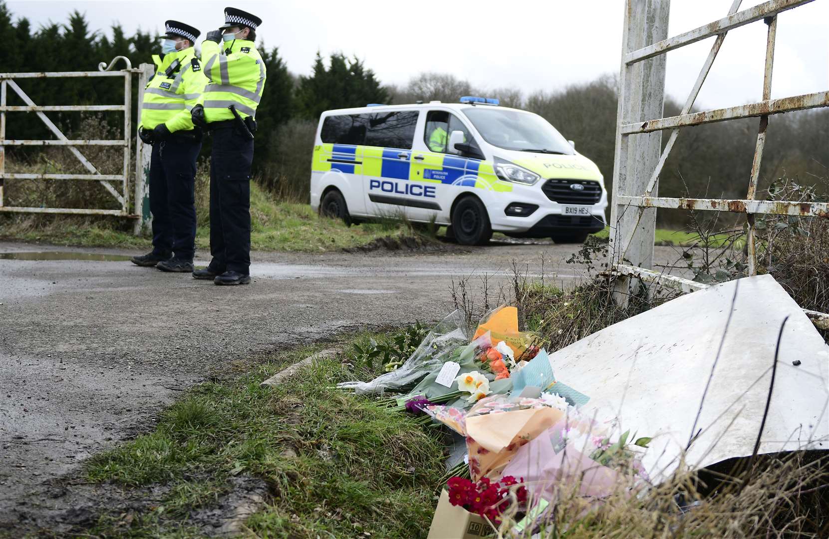 Flowers left by the public at the entrance to the search site in Great Chart. Picture: Barry Goodwin