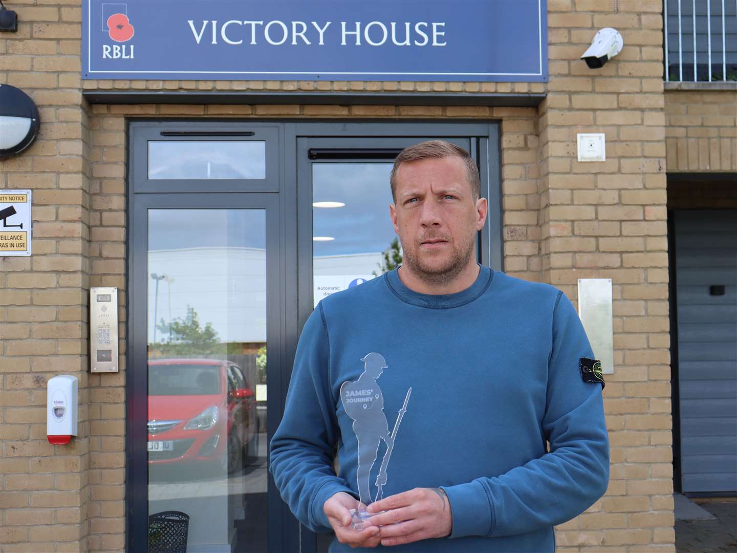 Jay holding a Tommy made by veterans in RBLI's Aylesford factory, in recognition for running 10k everyday in March for charity. Picture: RBLI