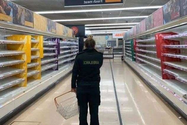 This picture of a paramedic looking at empty shelves in a Sainsbury's store has been circulating online Picture: Facebook
