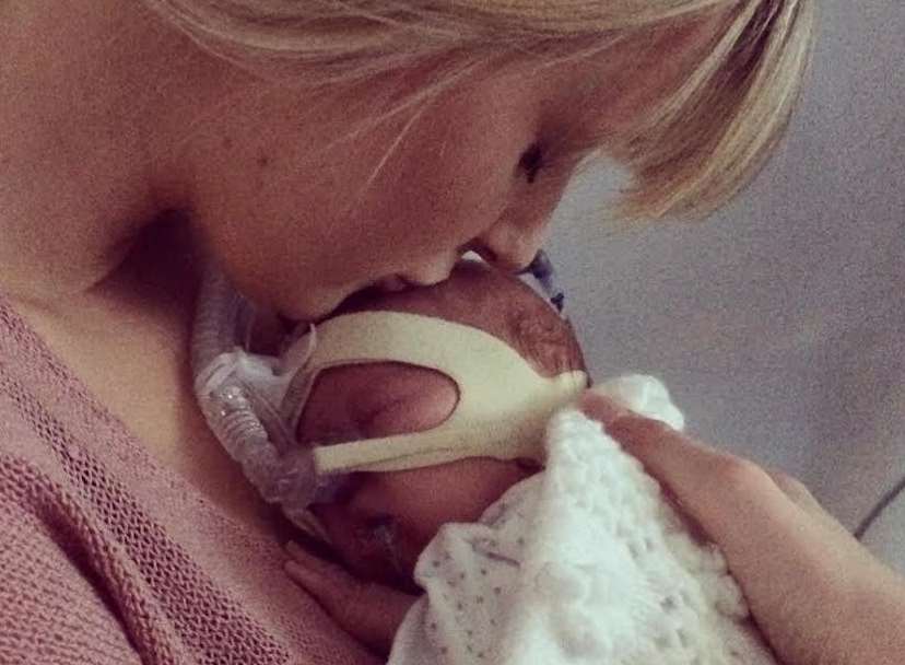 Ashley Gawler gives baby Ruby a gentle kiss