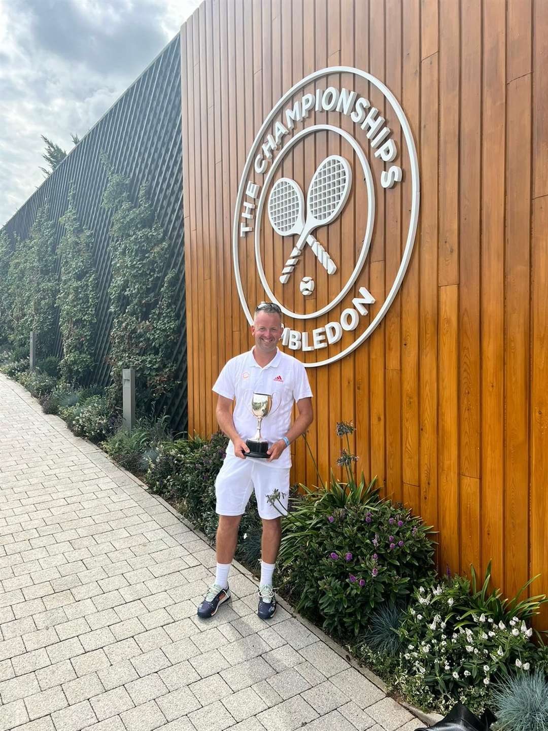 Zane Cheeseman with his over-40s singles trophy at the All England Club