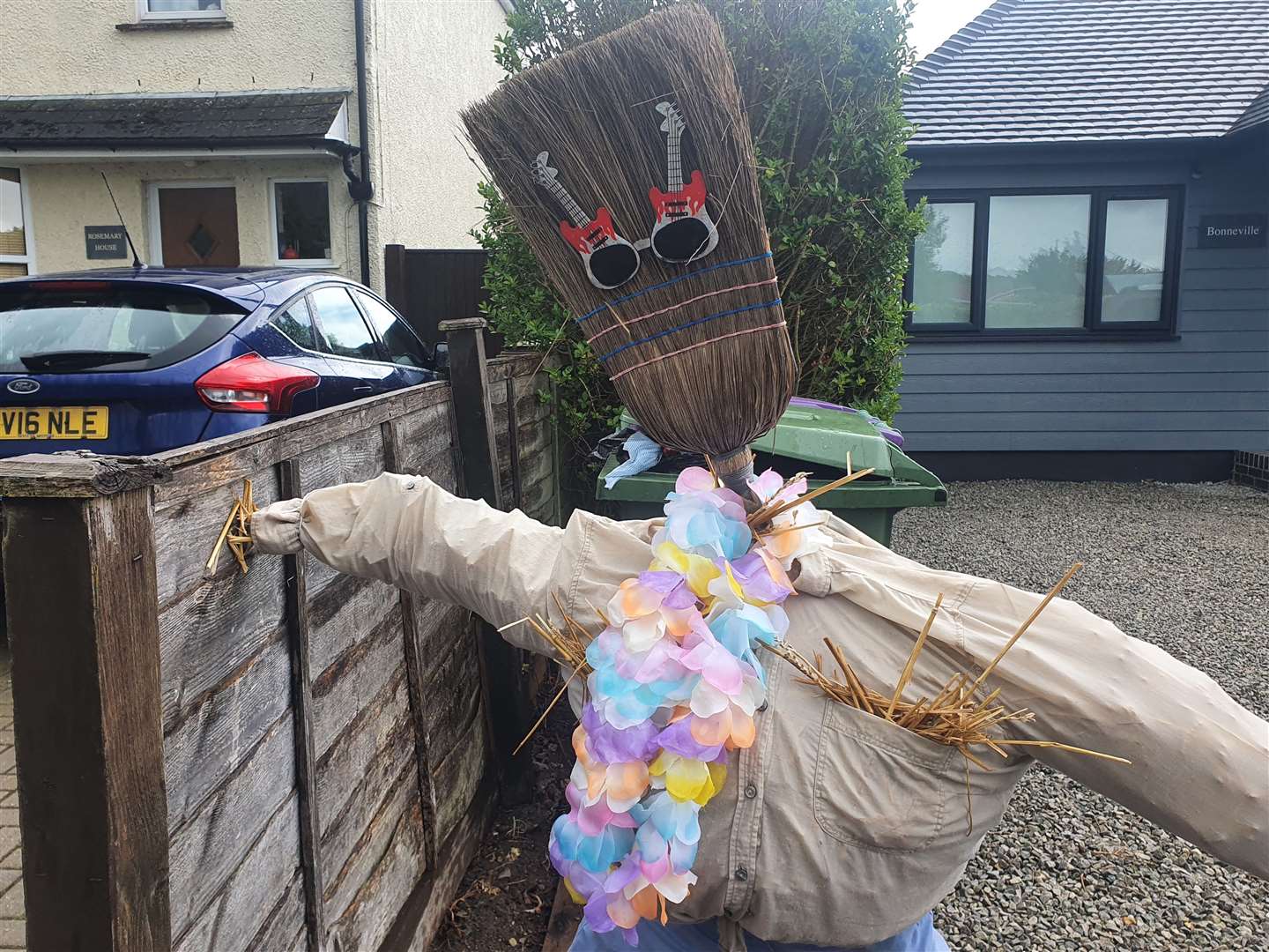 This scarecrow with a broom for a head is raising smiles