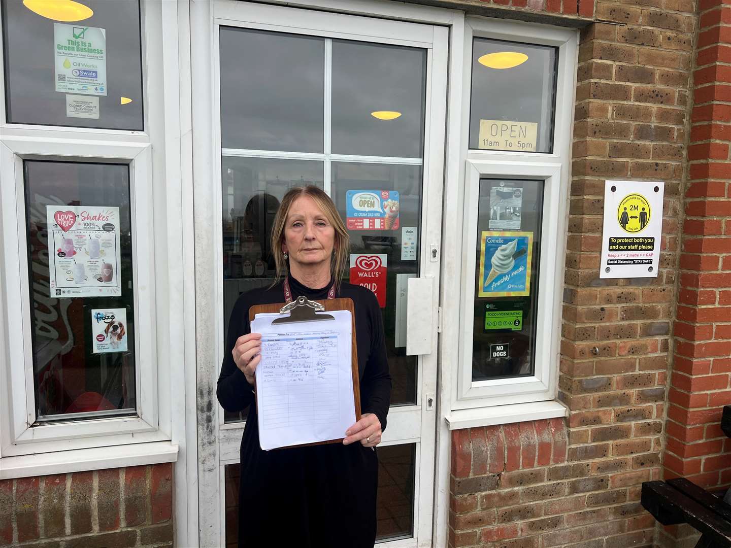 Marilyn Ward with the petition outside the Little Oyster Tea Room. Picture: Megan Carr