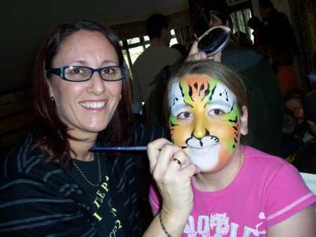 Ashford Rural Parents Forum staged a family day at the Rare Breeds Centre to attract new members and promote children's road safety skills. Face painter Sally Stratton is pictured painting Rebecca, nine, of Hamstreet School.