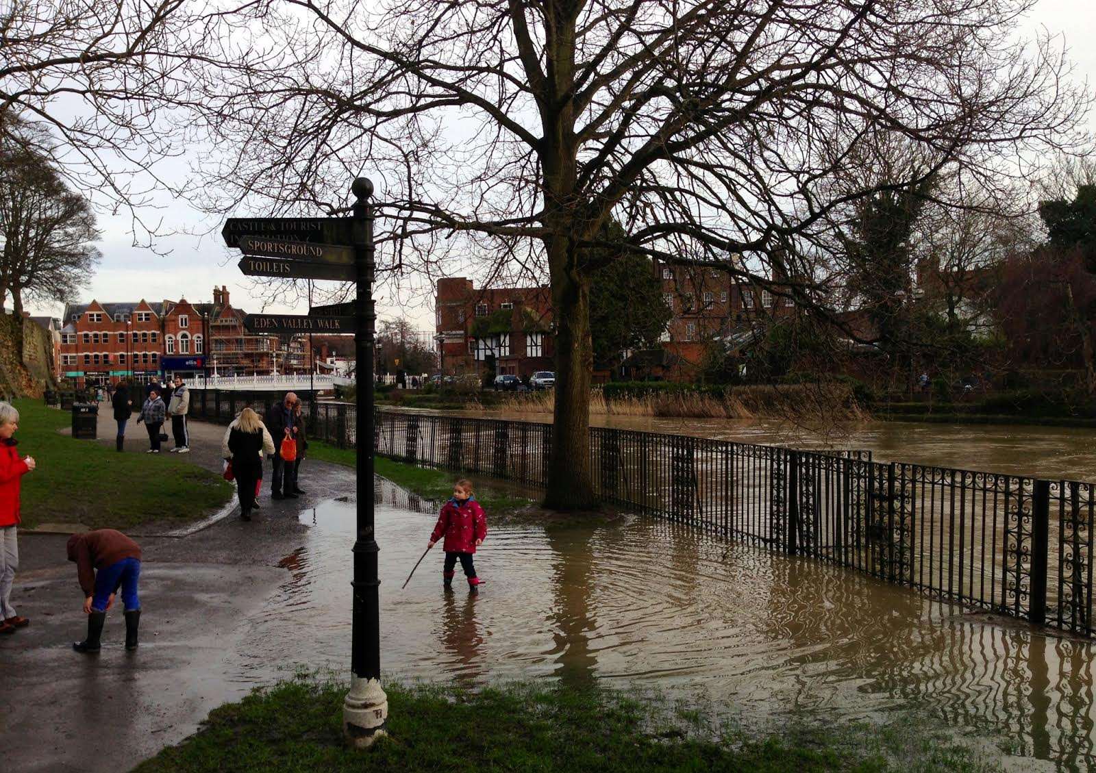 People survey the state of a flooded Tonbridge during the height of the rains. Picture by Matthew Walker