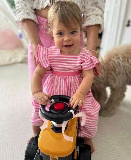 Jessica and Christopher’s daughter riding a JCB toy. Picture: Diggerland