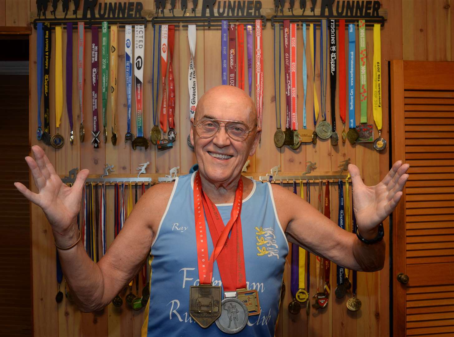 Marathon runner Ray Johnson, 82, with his medals