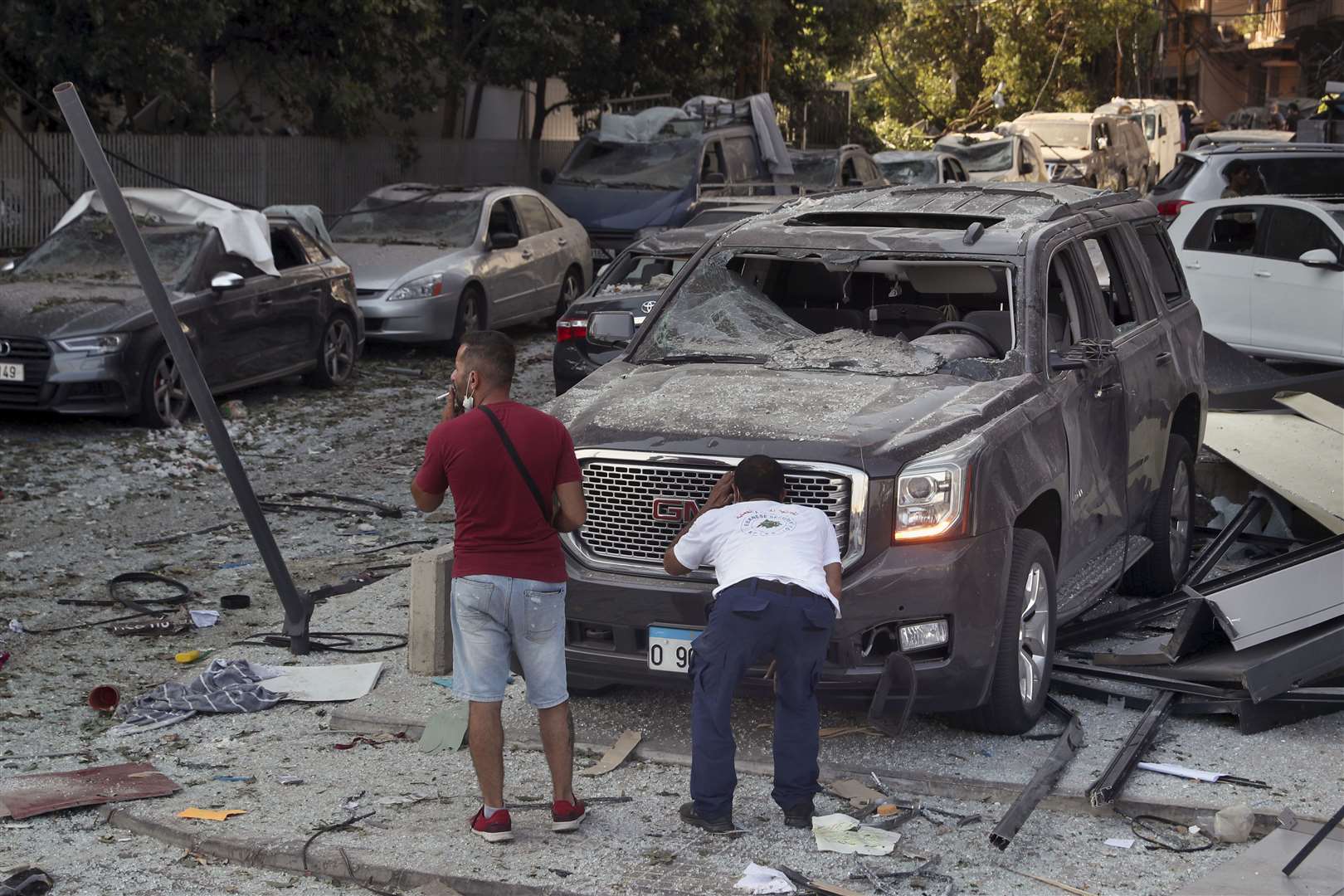 A man inspects his a damaged car after a massive explosion in Beirut (AP/Bilal Hussein)