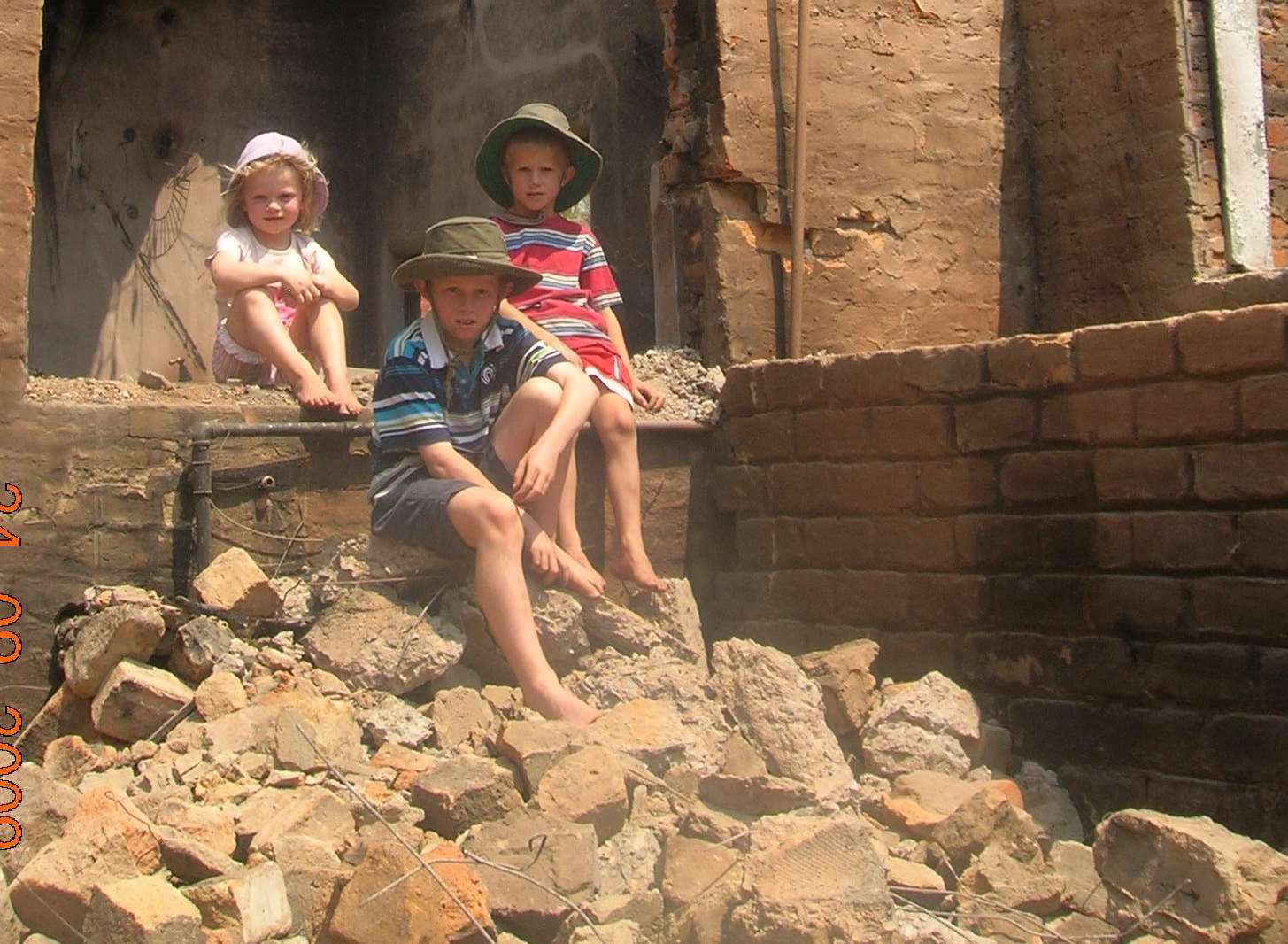Ben and Laura’s children (from the left) Anna, Joshua and Stephen in the ruins of the home where they had been so happy