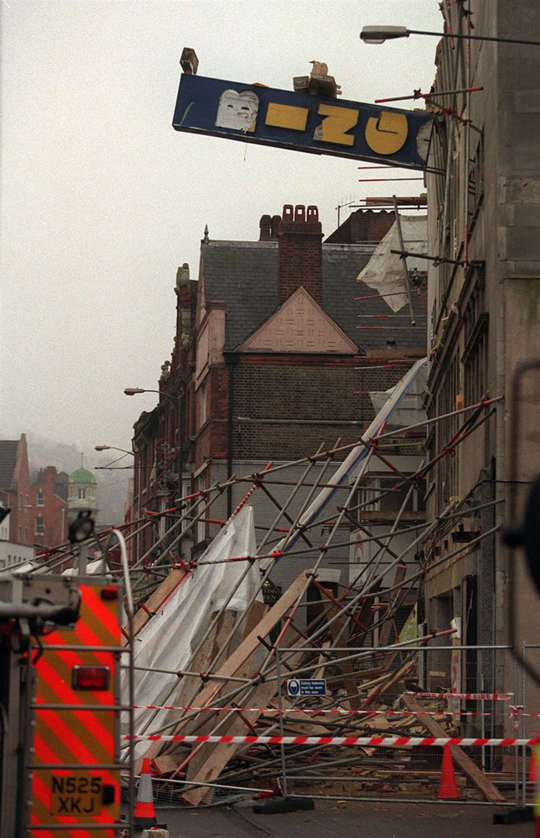 The bingo advertising sign hangs perilously after part of the building collapsed during demolition work on November 25, 1998