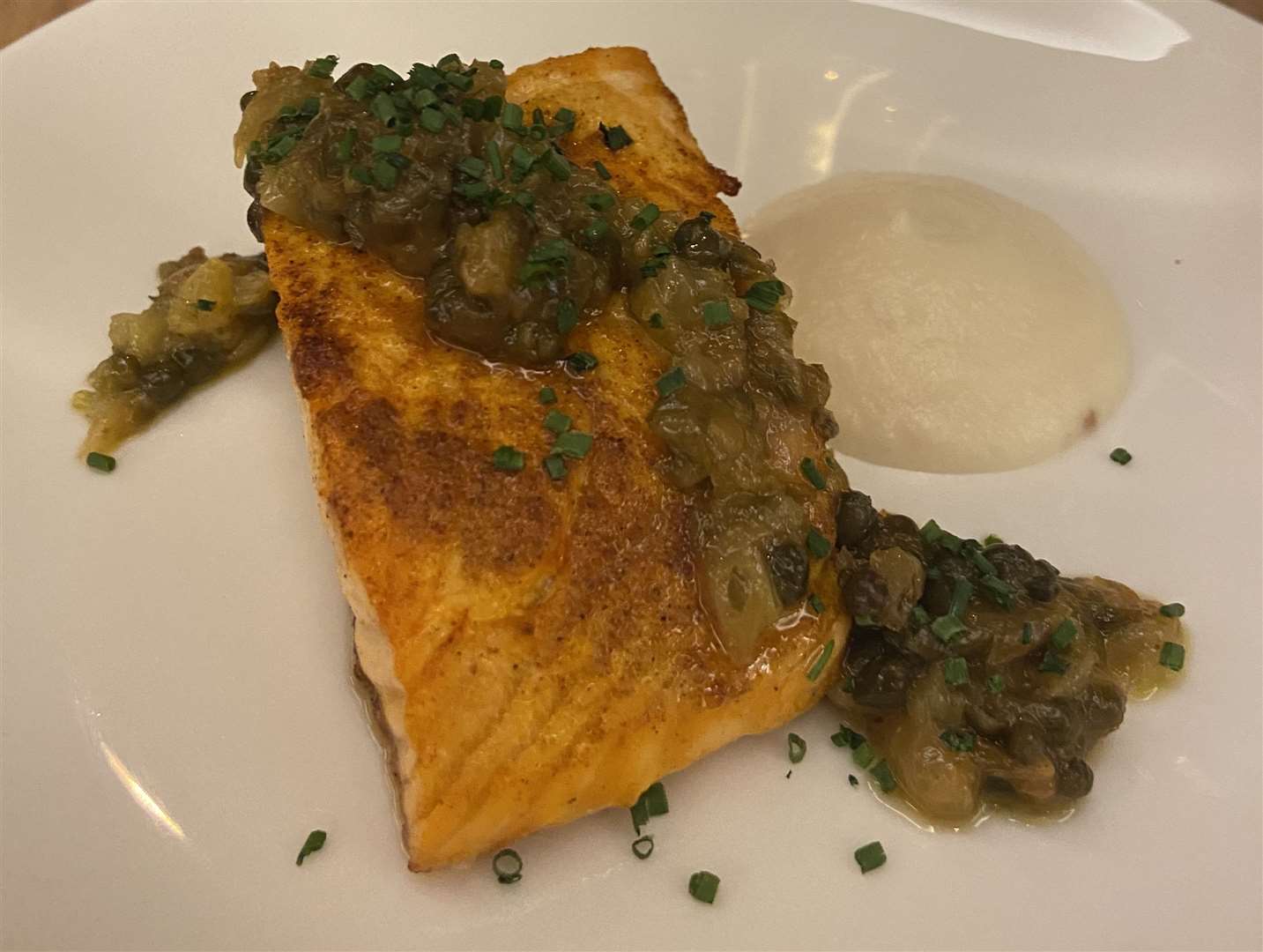 Roasted salmon with cauliflower puree and caper and raisin dressing