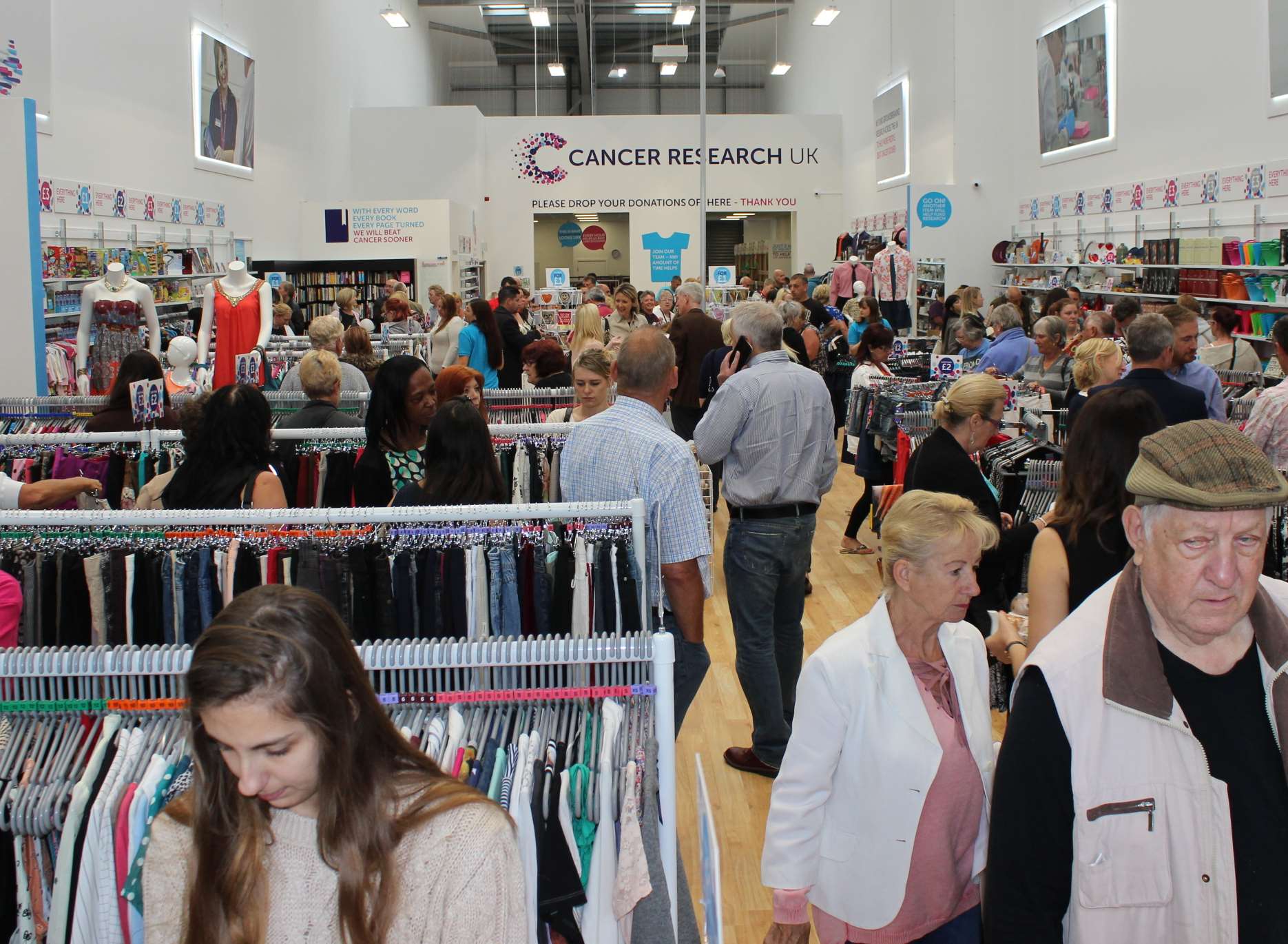 Lots of shoppers in the Cancer UK Research charity shop at Neats Court