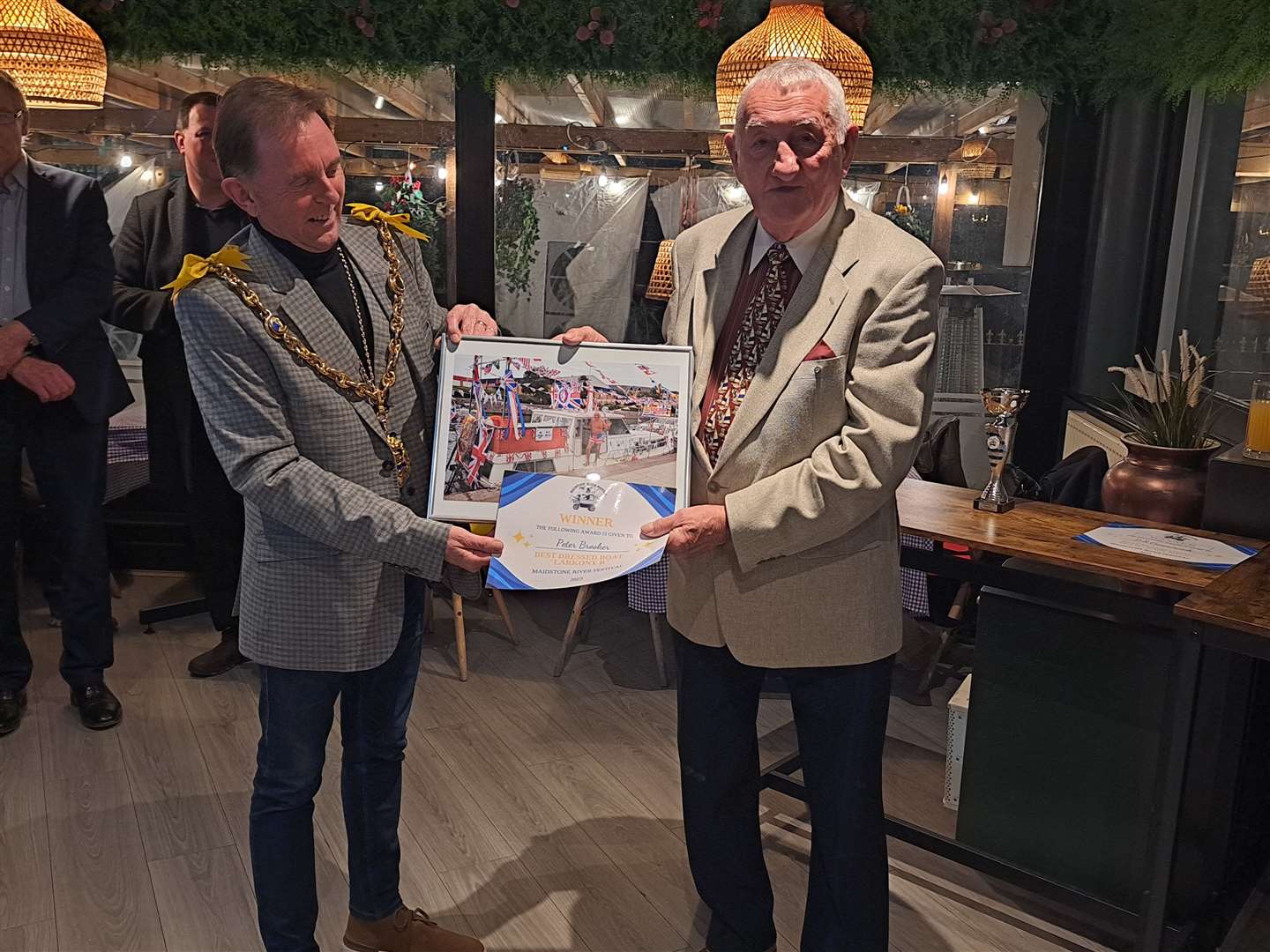 The Mayor presents a prize to the winner of the best dressed craft, Peter Brooker