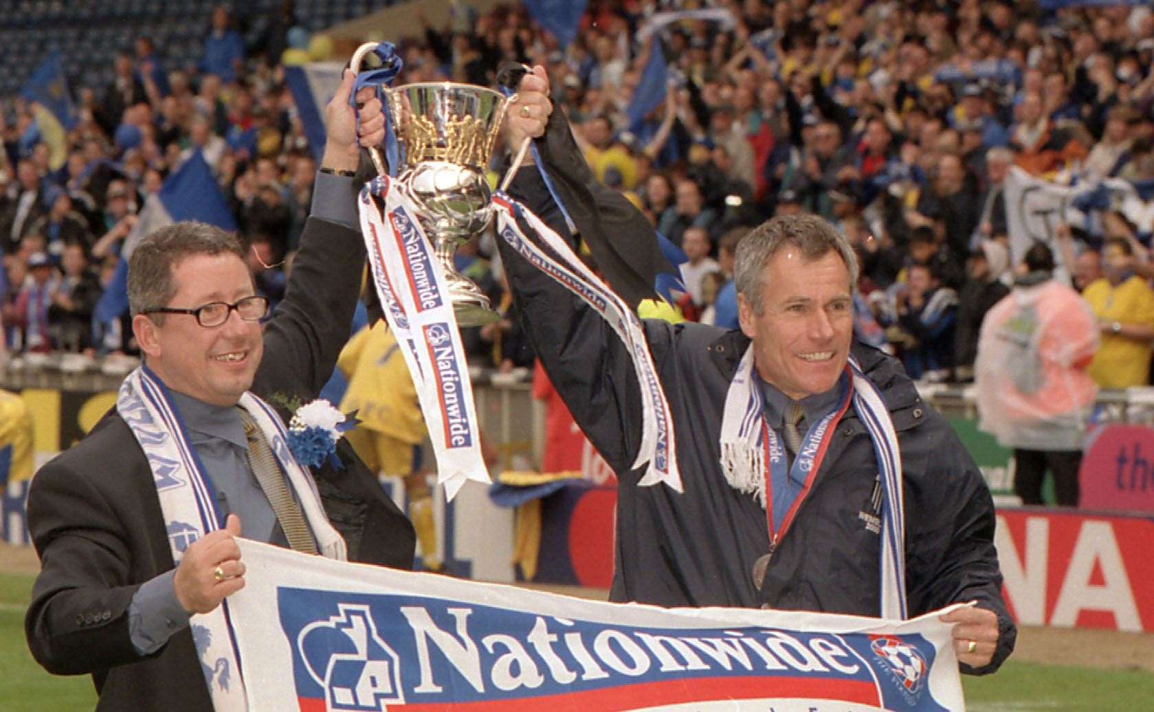 Paul Scally celebrates promotion in the play-off final at Wembley with manager Peter Taylor