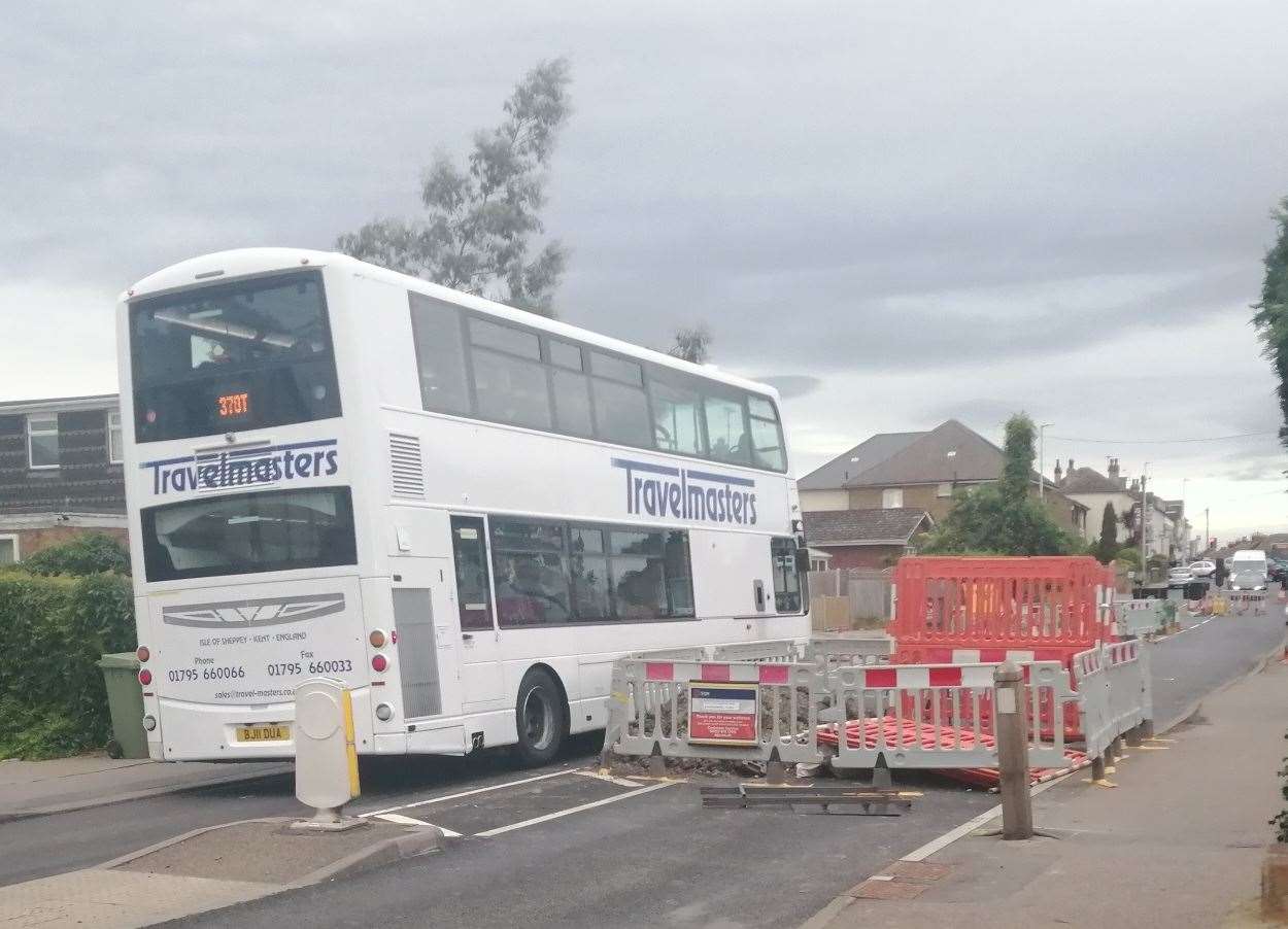 Travelmasters school bus makes it way towards the barrier, which had been moved, in Minster Road, Halfway, Sheppey. The SGN roadworks are still visible. Picture: David Jones
