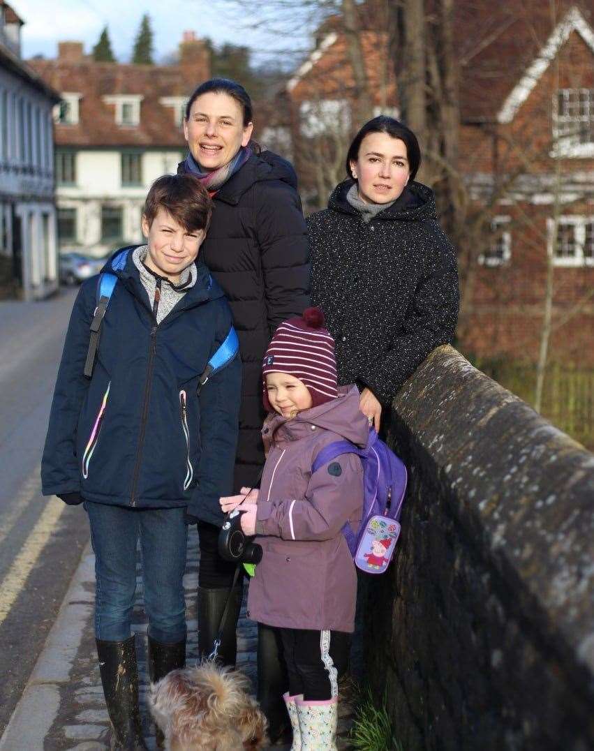 Town Bridge, Yalding. Robin Schuldenfrei (centre left) with son Theo, and two Ukrainian visitors, Vira Tsypuk (adult, right) and Polina Yurasova (child)