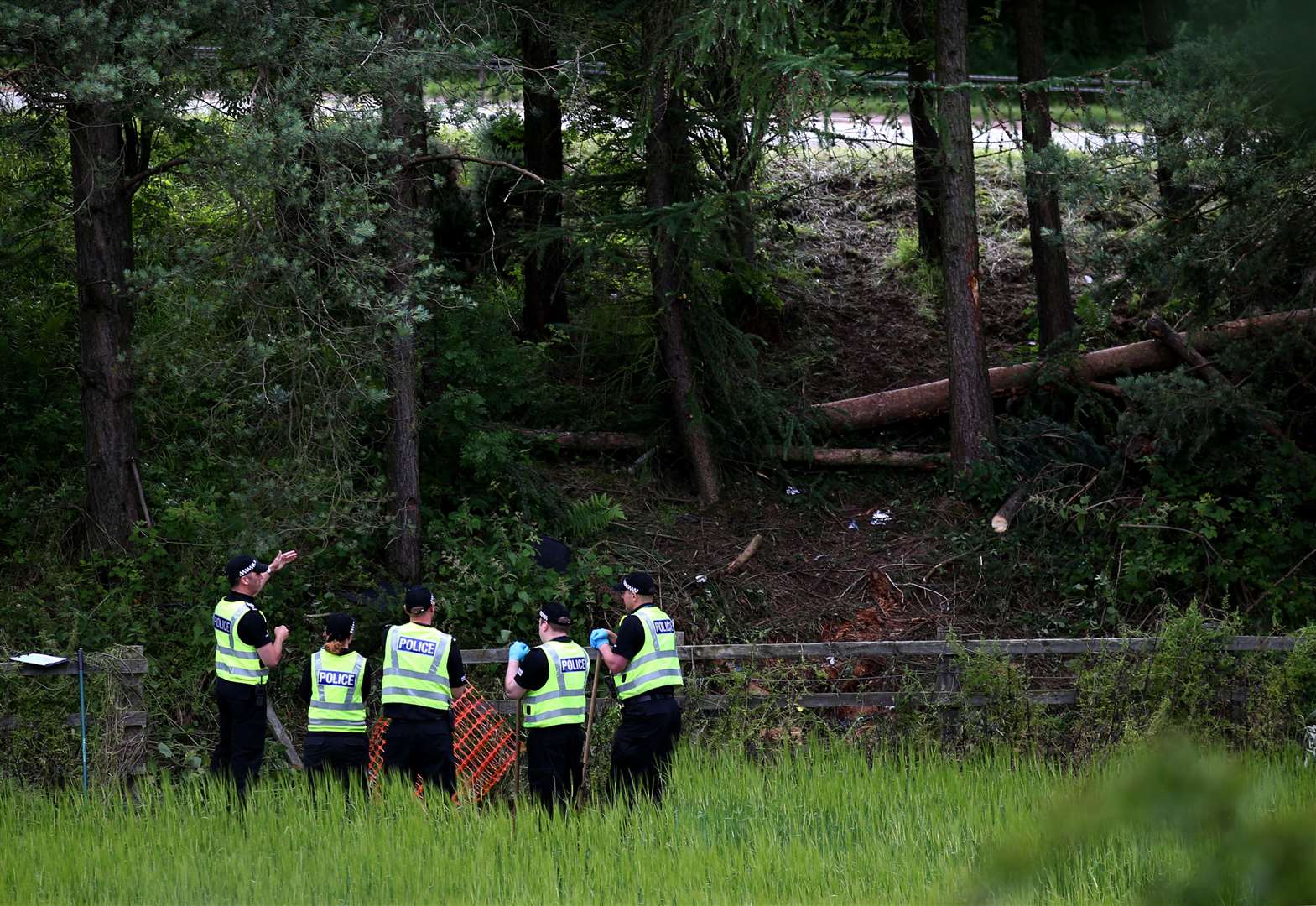 Police officers search at the crash site (Andrew Milligan/PA)