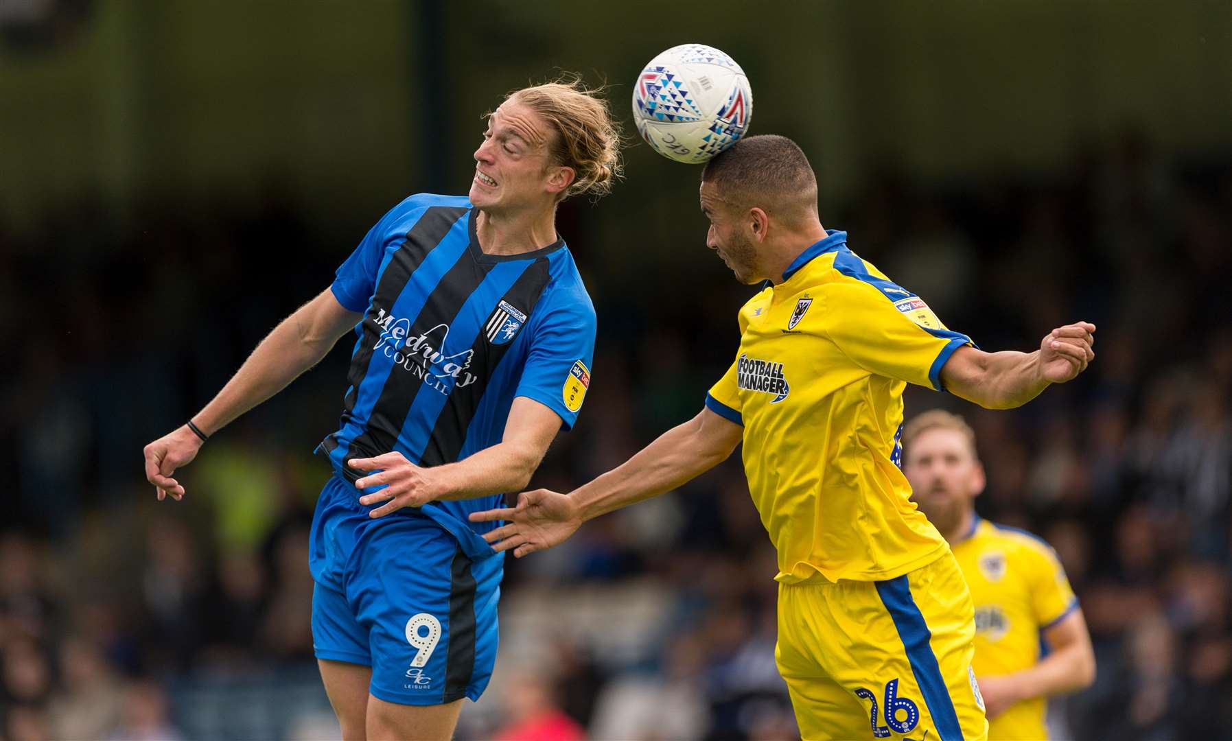 Gills striker Tom Eaves challenges Wimbledon's Rod McDonald. Picture: Ady Kerry