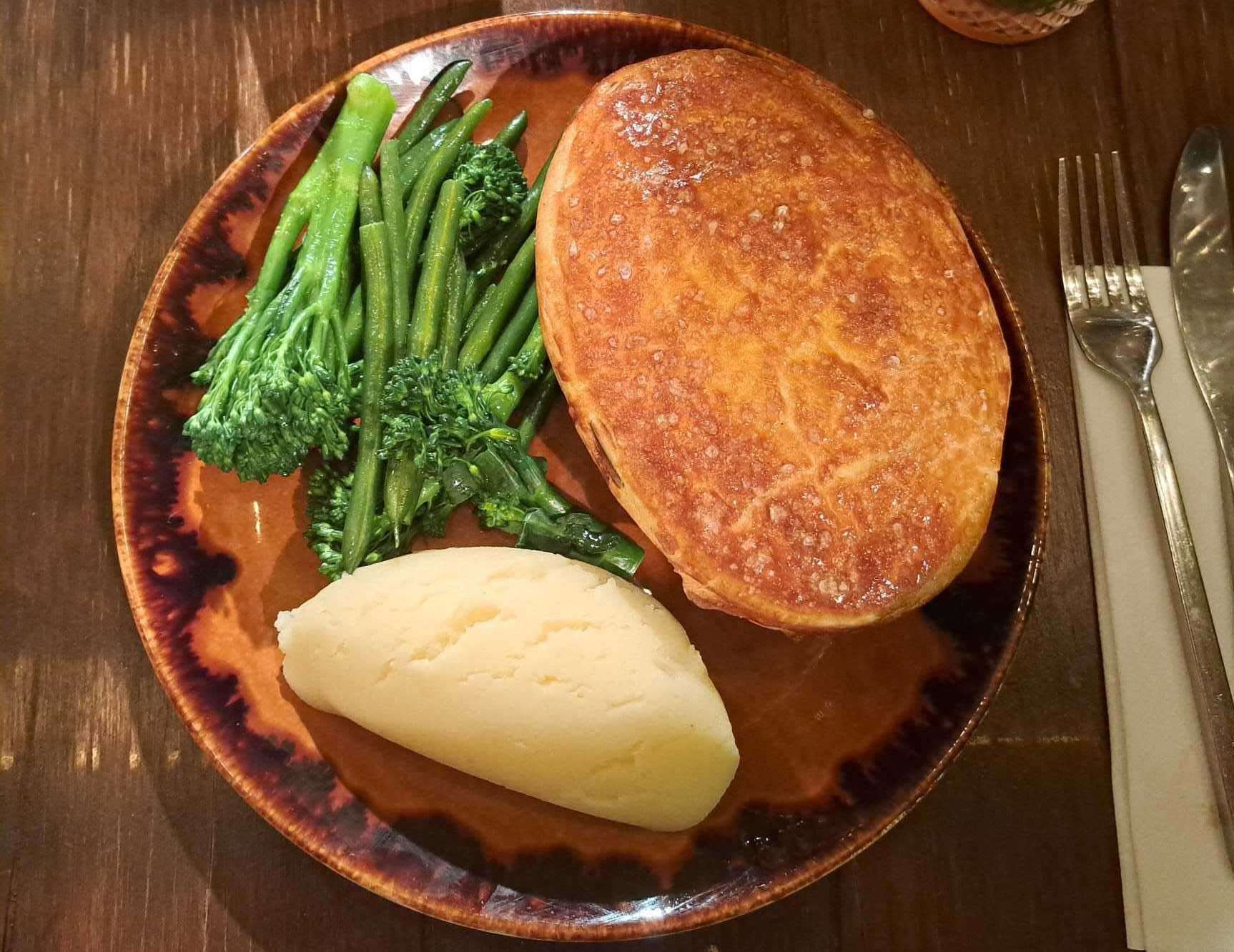 Steak and ale pie with buttered mash and steamed greens