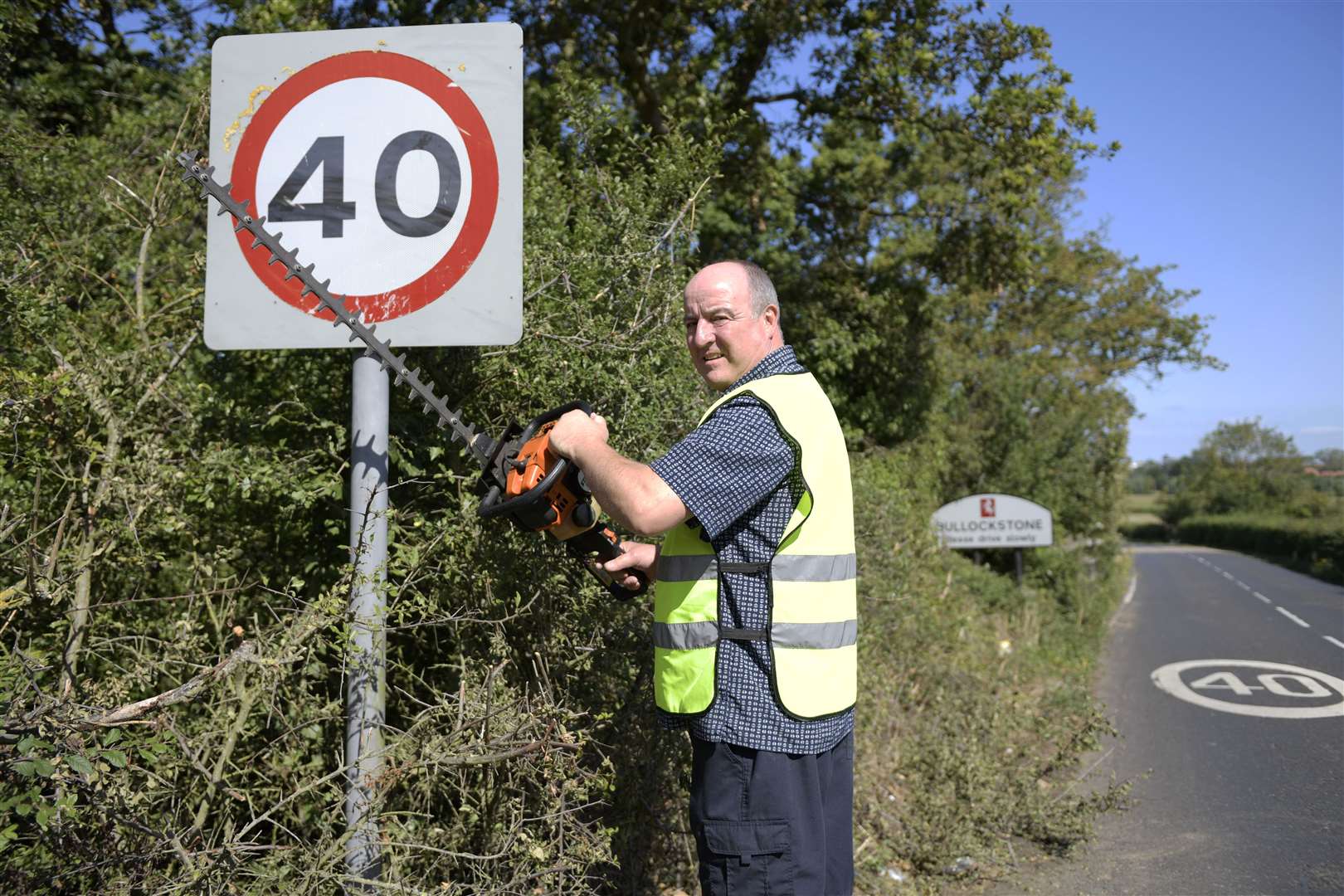 Joe Ellis has been cutting bushes obscuring view of road signs along Bullockstone Road for 20 years. Picture: Barry Goodwin