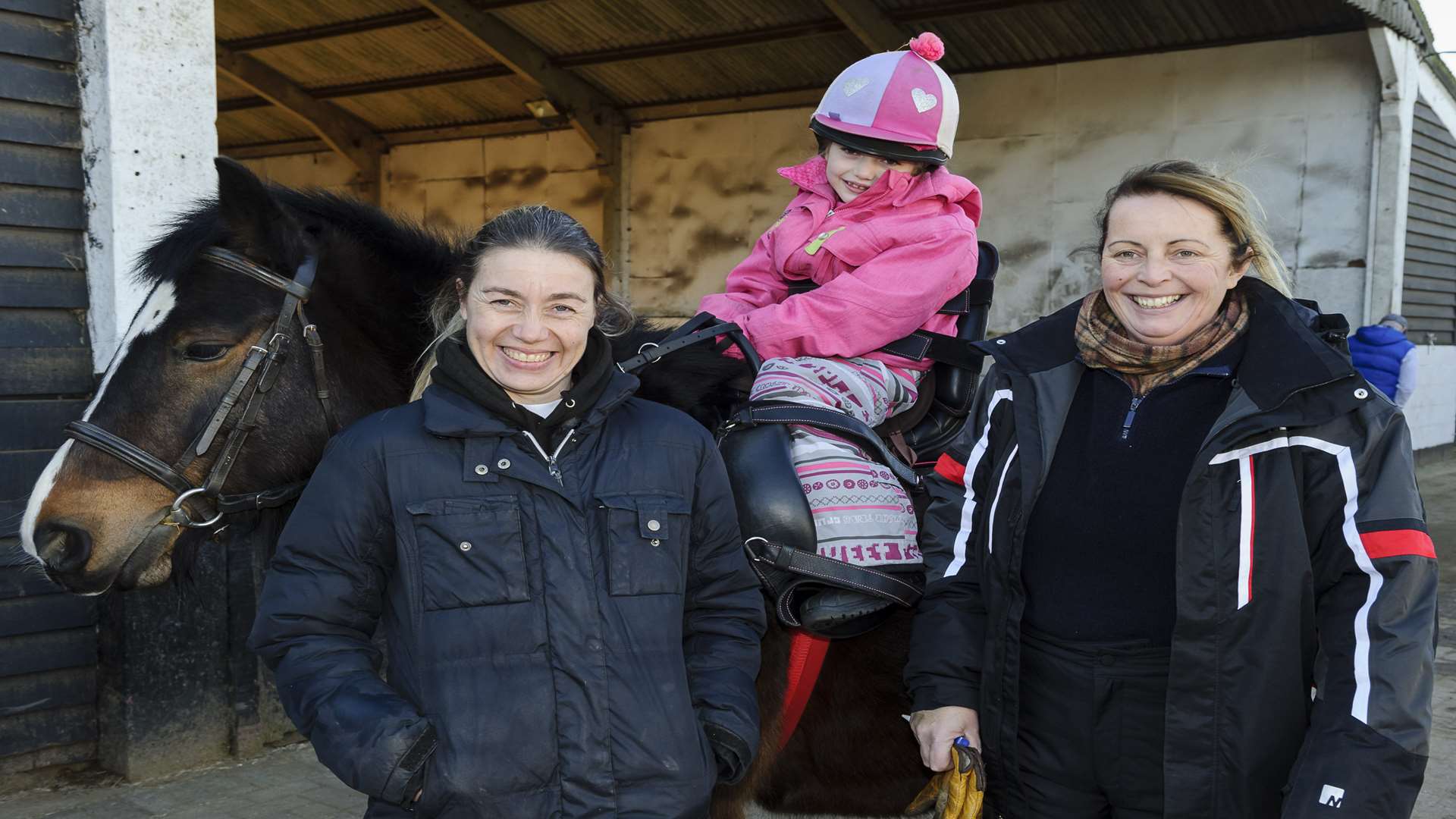 Issy, riding Dolly, with mum Tracey Rose, left, and equestrian centre proprietor Carole Kennerly