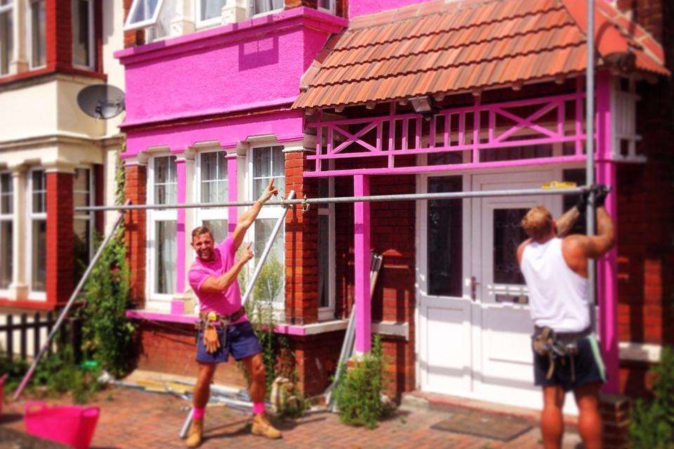 Jon Ansett in action painting his friend Peter Price-Whittle's house pink