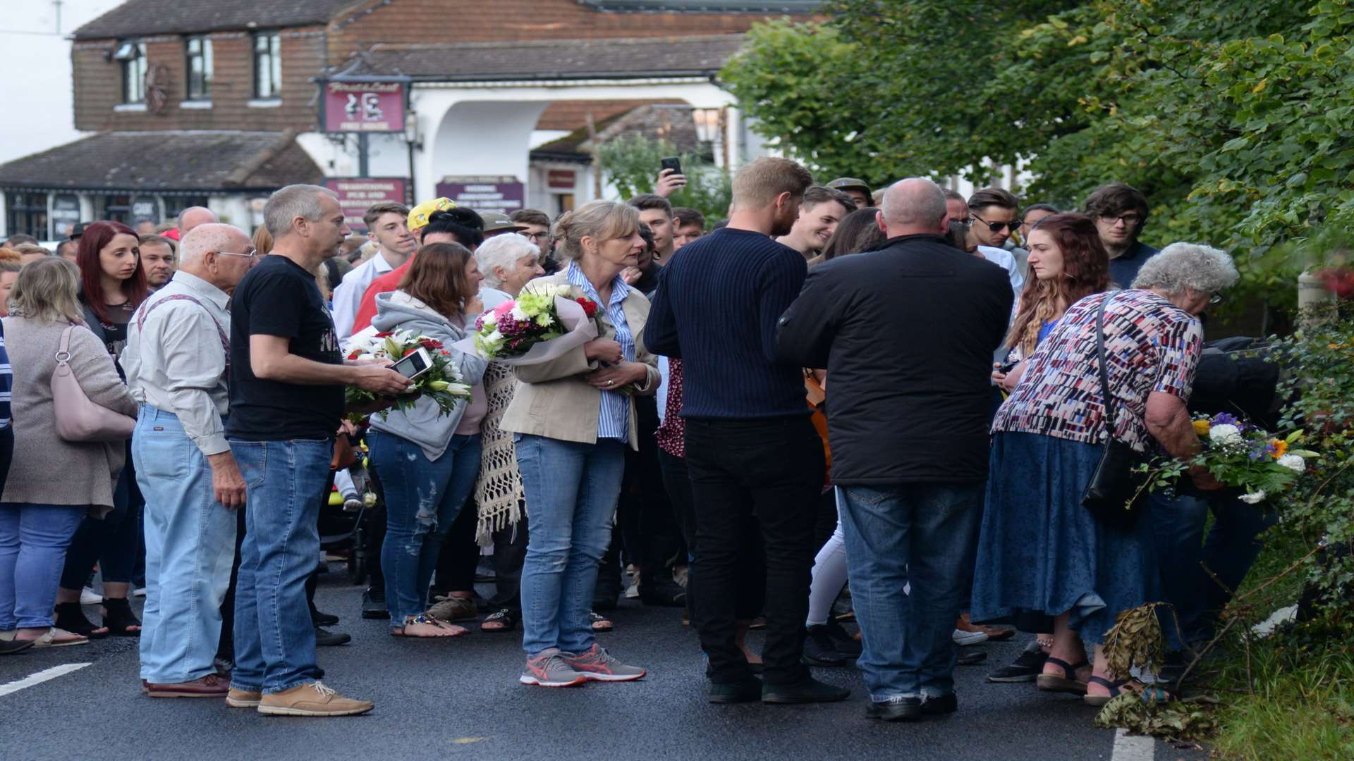 Family and friends of Jack Whichello on the Canterbury Road, Herne for the laying of floral tributes this evening