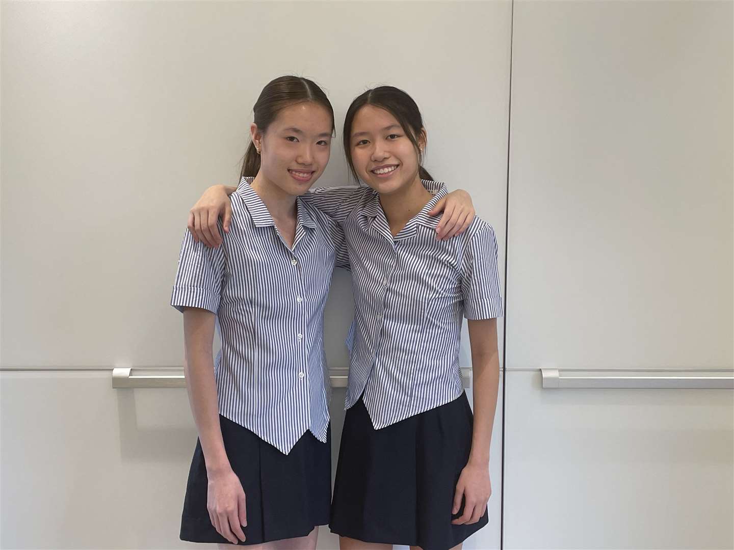 Nicola, Left, and Victoria Tsang celebrating their identical GCSE results today. Photo: Benenden School (58893652)