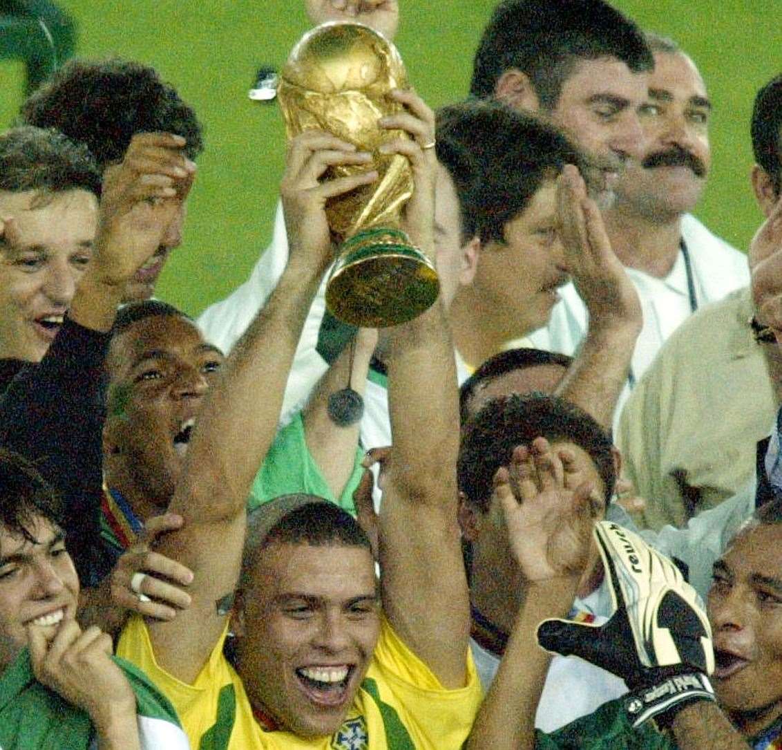 His haircut is similar to the one once donned by Brazilan striker Ronaldo, pictured lifting the World Cup in 2002. Picture: AP Photo / David Guttenfelder
