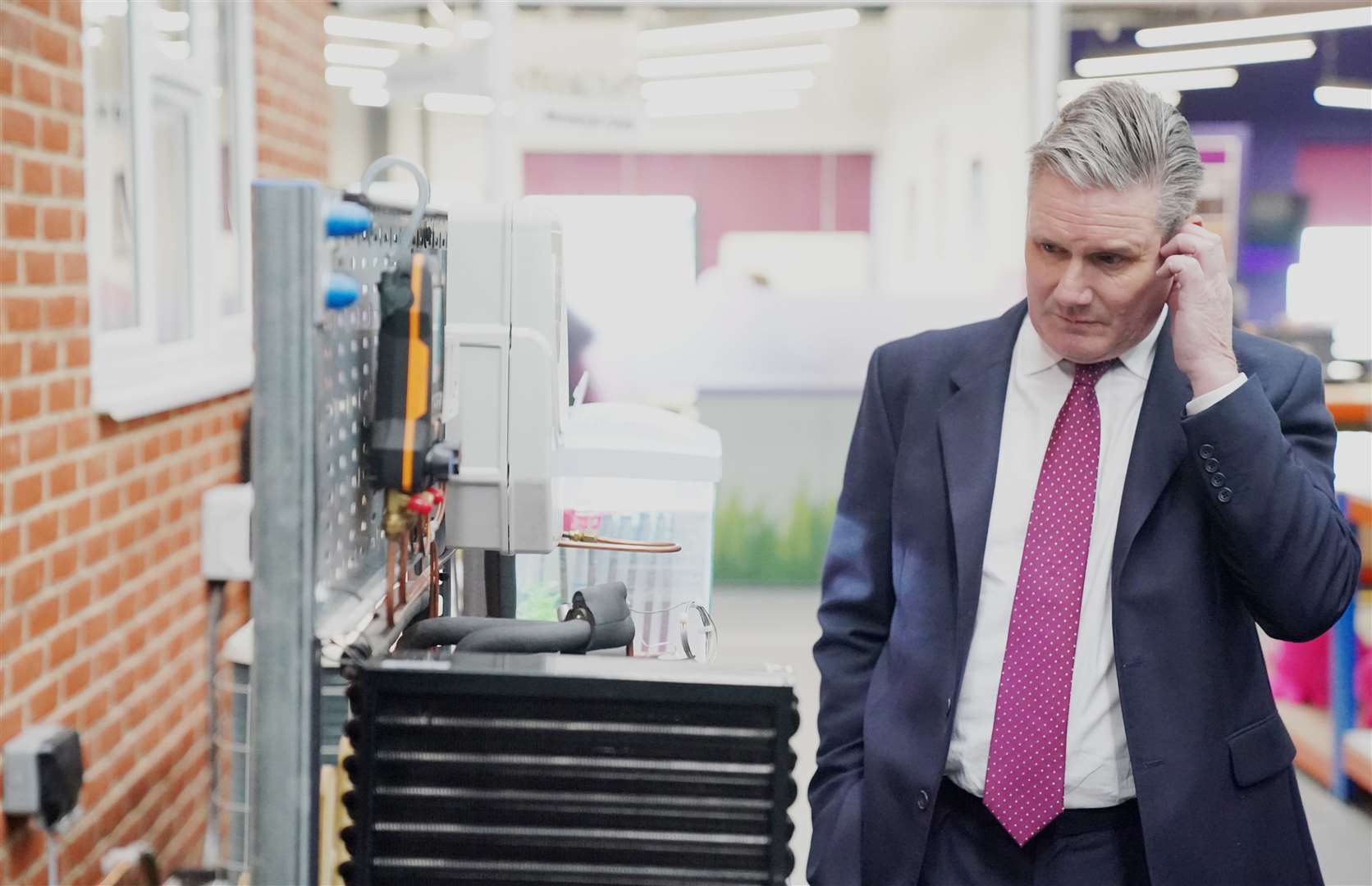 Labour party leader Sir Keir Starmer inspects a heat pump demonstrator during a visit to renewable energy company, Octopus Energy (Jonathan Brady/PA)